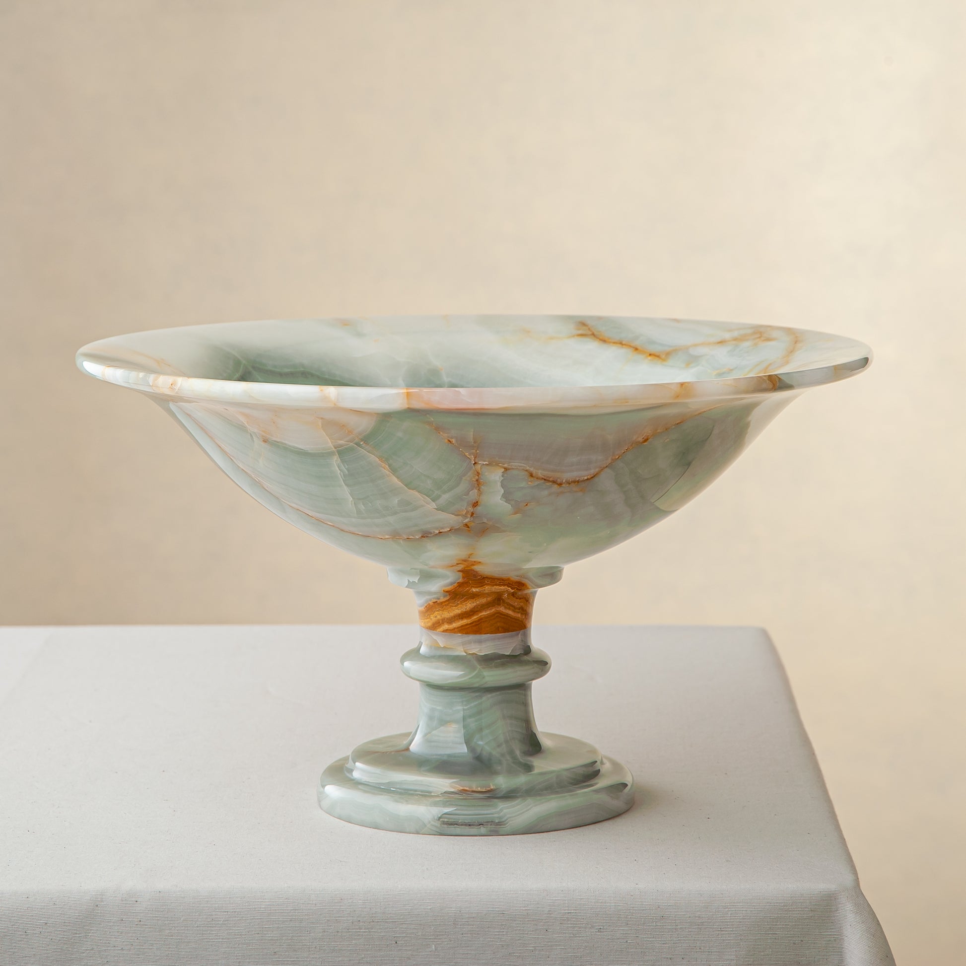 handcrafted green onyx bowl with amber veining and translucent surface for luxury decor
