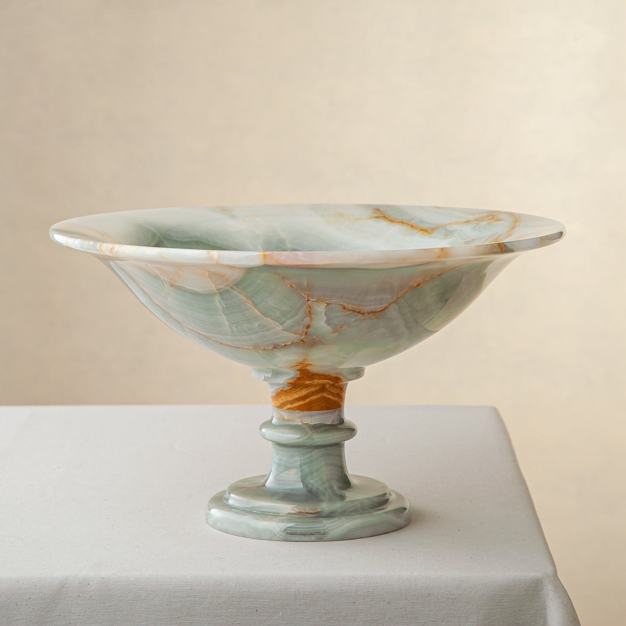 handcrafted green onyx bowl with amber veining and translucent surface for luxury decor
