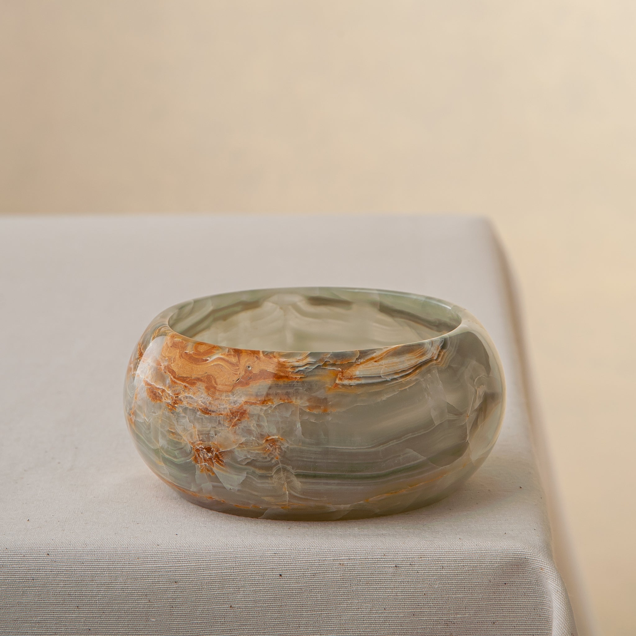 handcrafted onyx bowl with green and amber veining for luxury table decor
