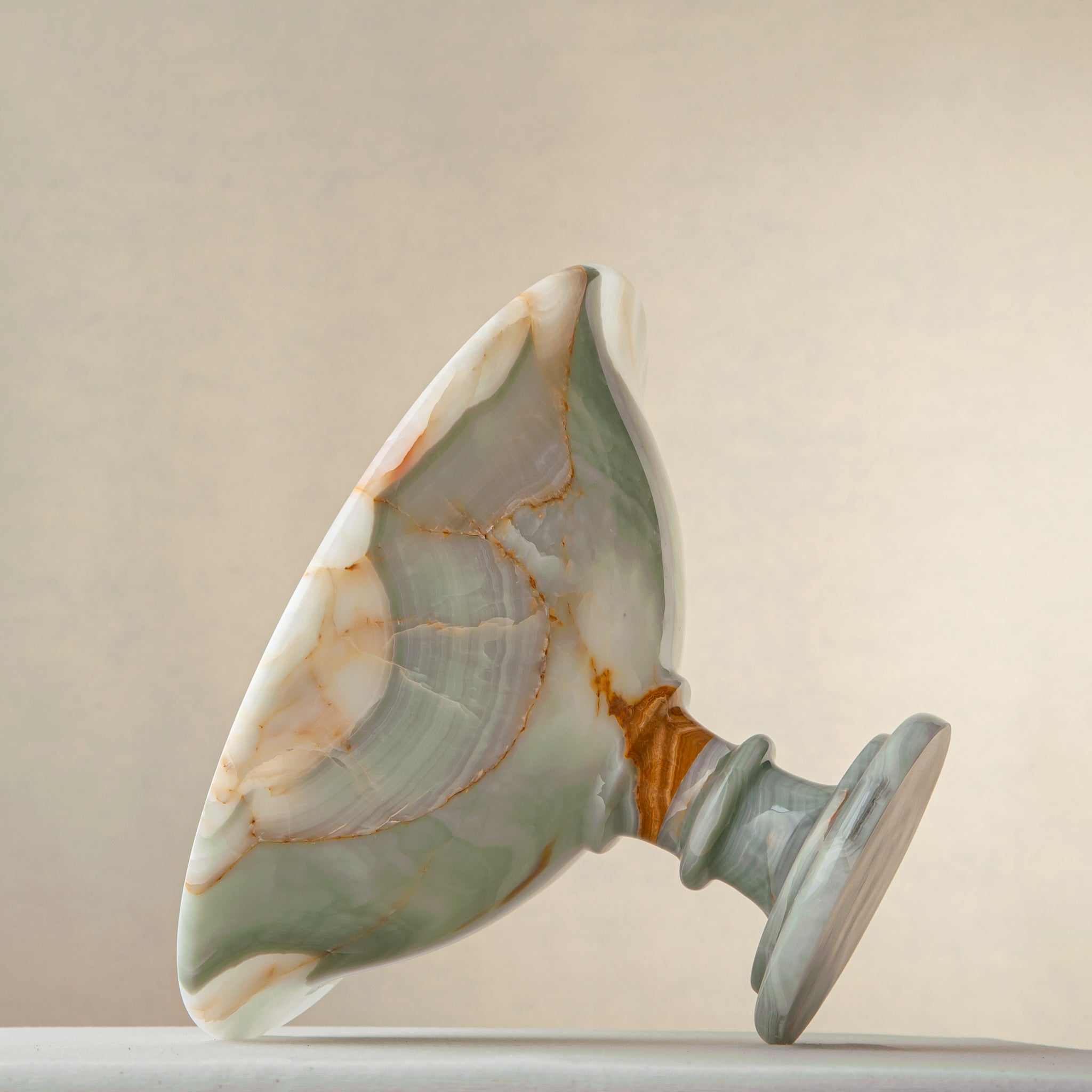 handcrafted green onyx bowl with amber veining and translucent surface for luxury decor
