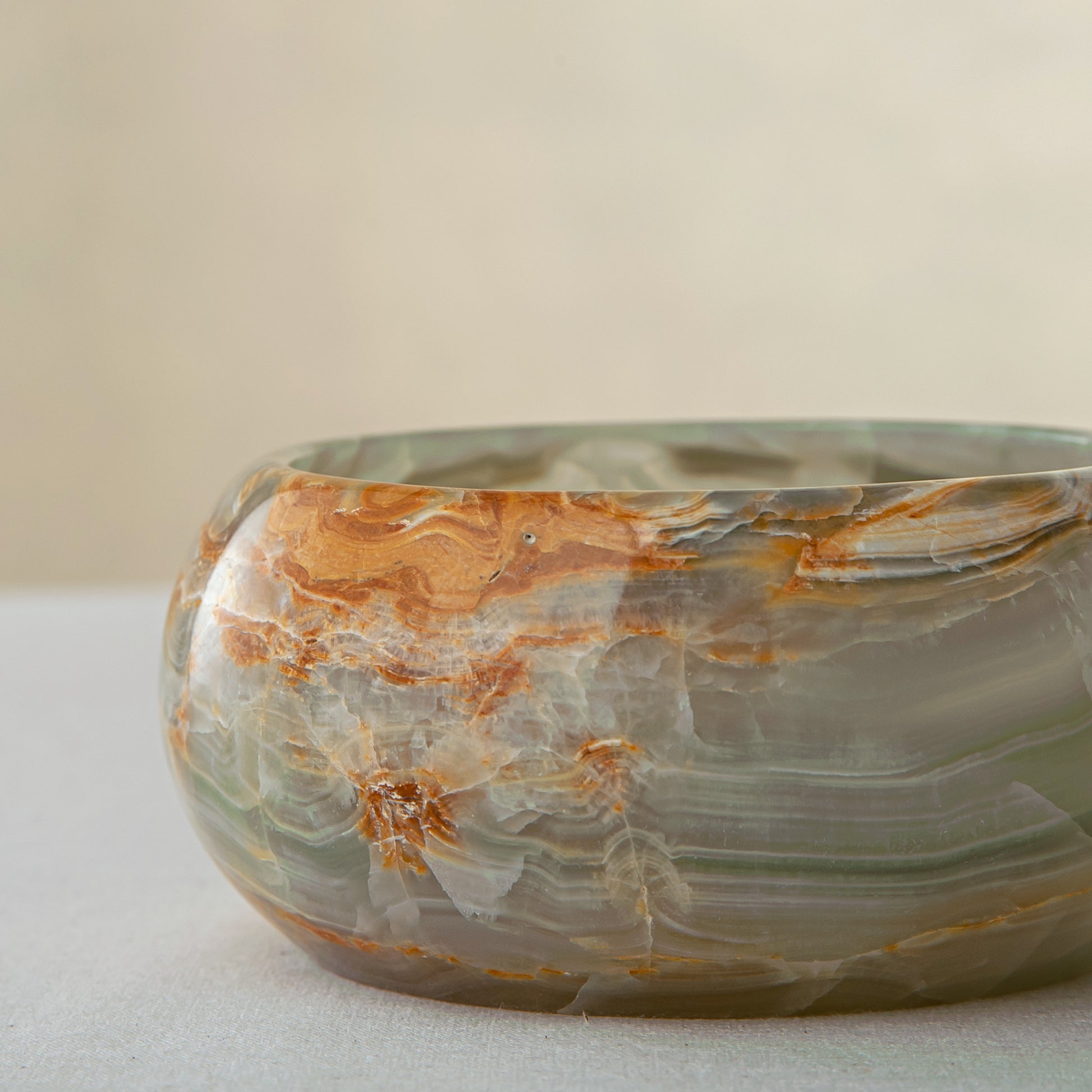 handcrafted onyx bowl with green and amber veining for luxury table decor
