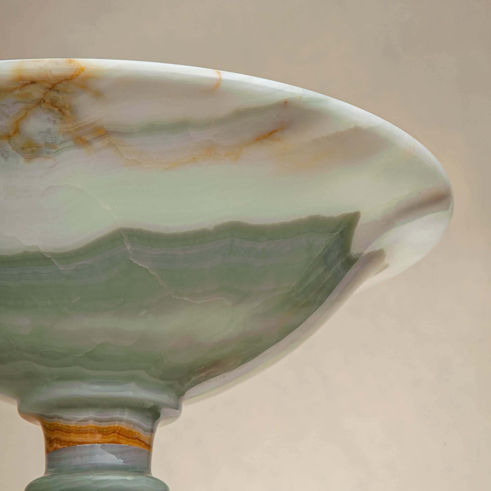handcrafted green onyx bowl with amber veining and translucent surface for luxury decor
