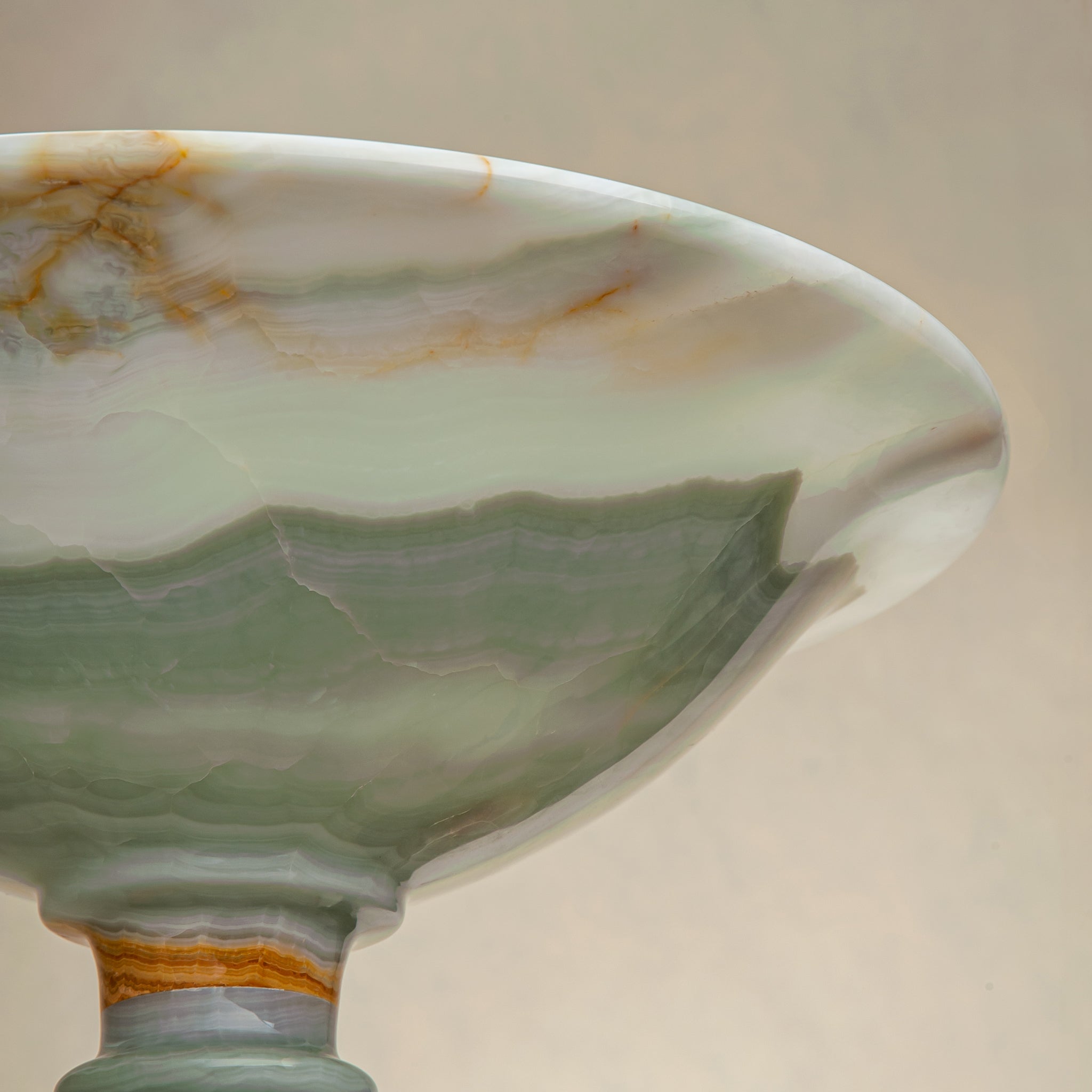 handcrafted green onyx bowl with amber veining and translucent surface for luxury decor
