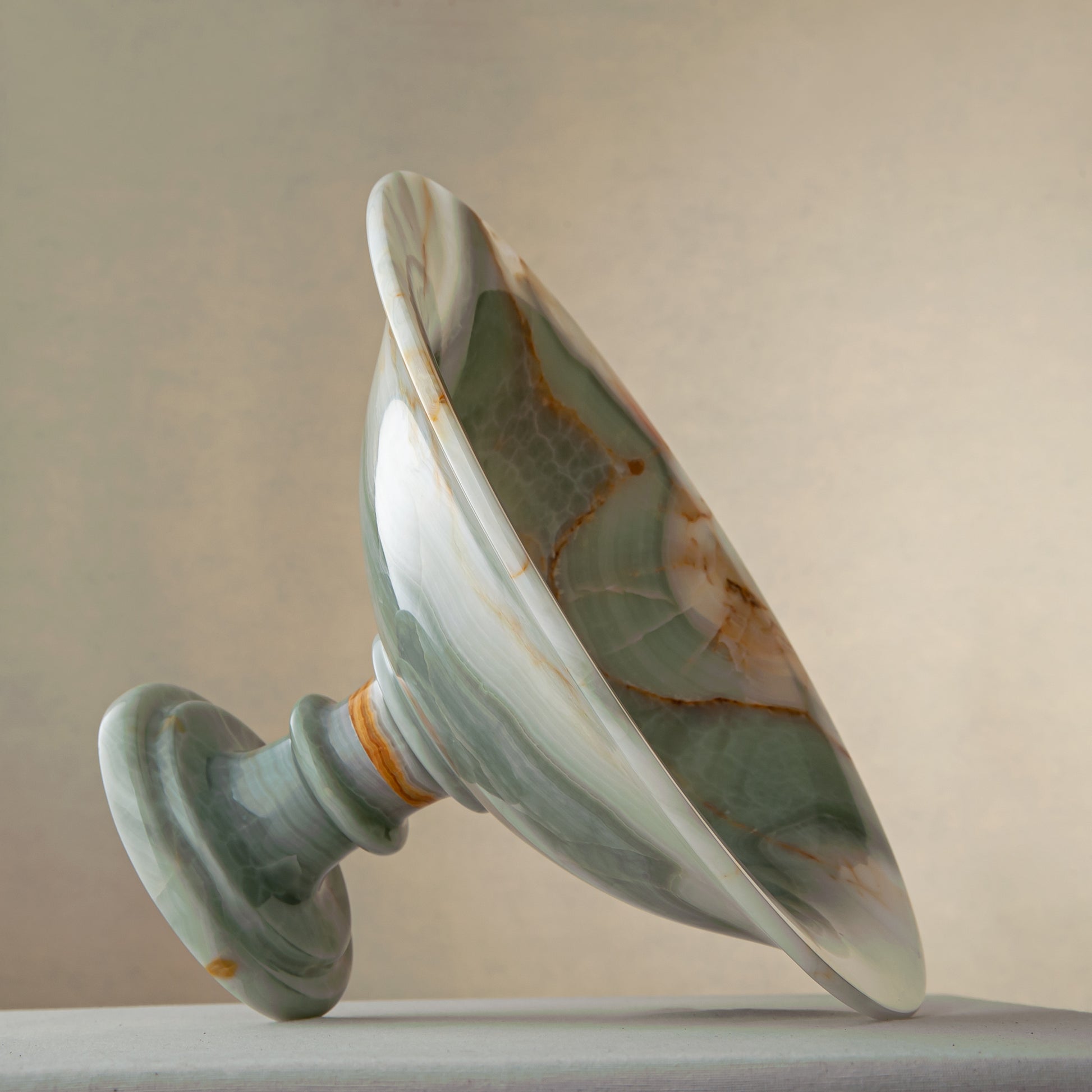 handcrafted green onyx bowl with amber veining and translucent surface for luxury decor
