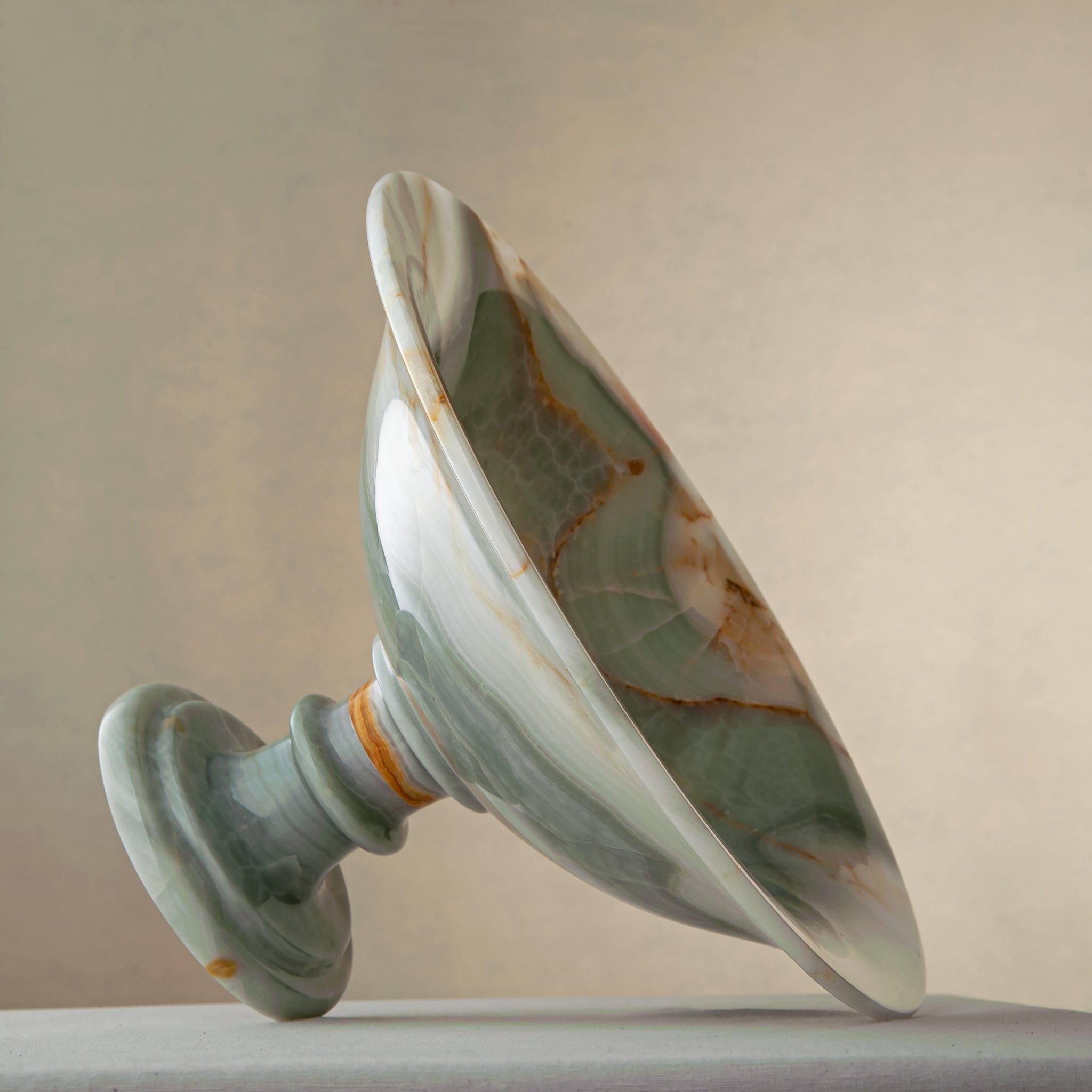 handcrafted green onyx bowl with amber veining and translucent surface for luxury decor
