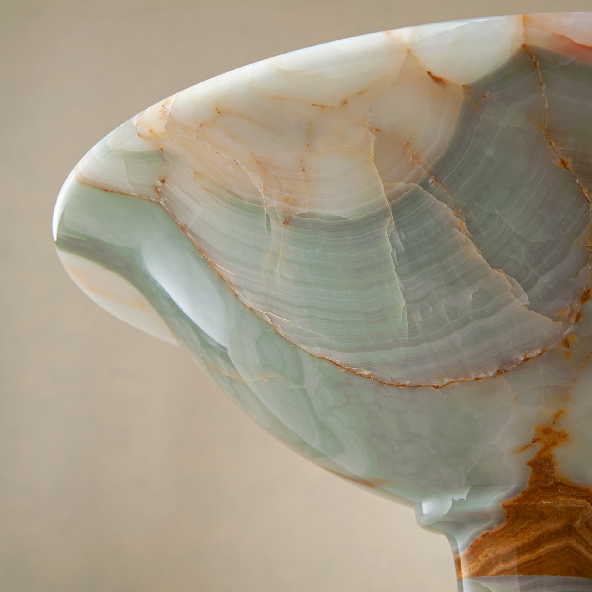 handcrafted green onyx bowl with amber veining and translucent surface for luxury decor
