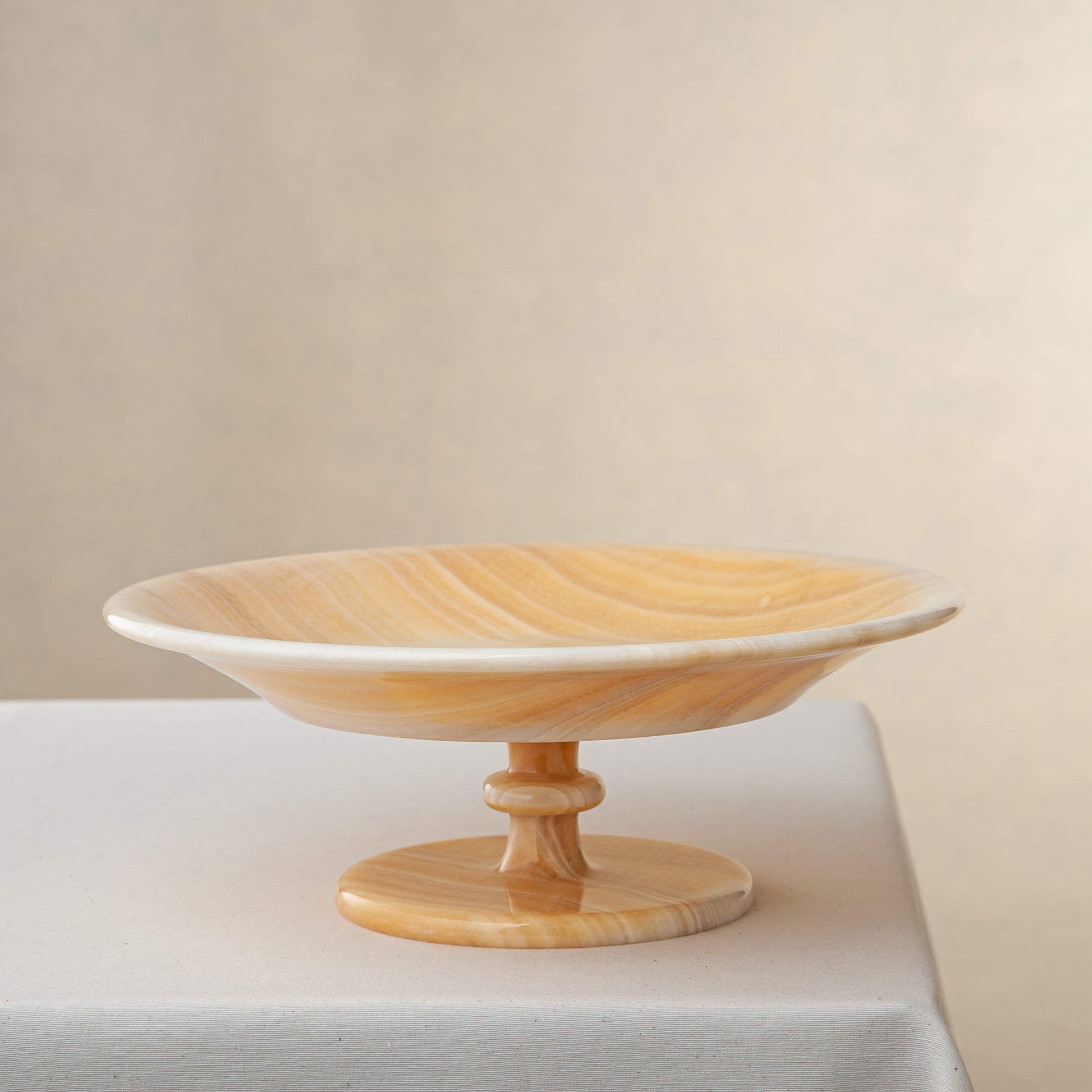 unique natural onyx bowl with warm flowing layers and luminous surface centerpiece
