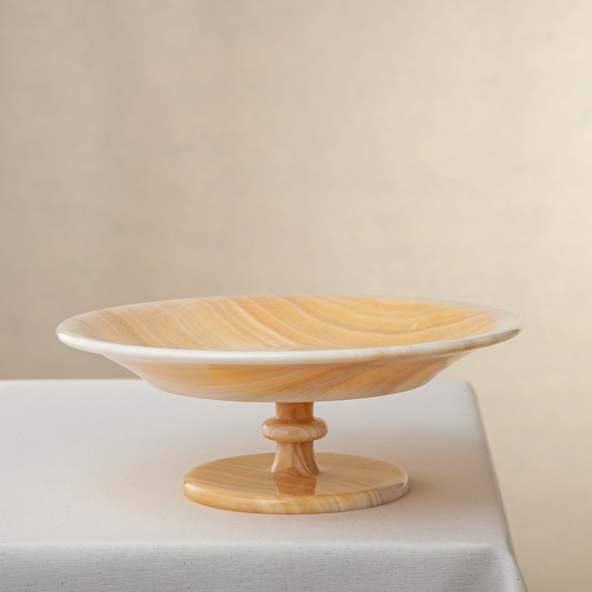 unique natural onyx bowl with warm flowing layers and luminous surface centerpiece
