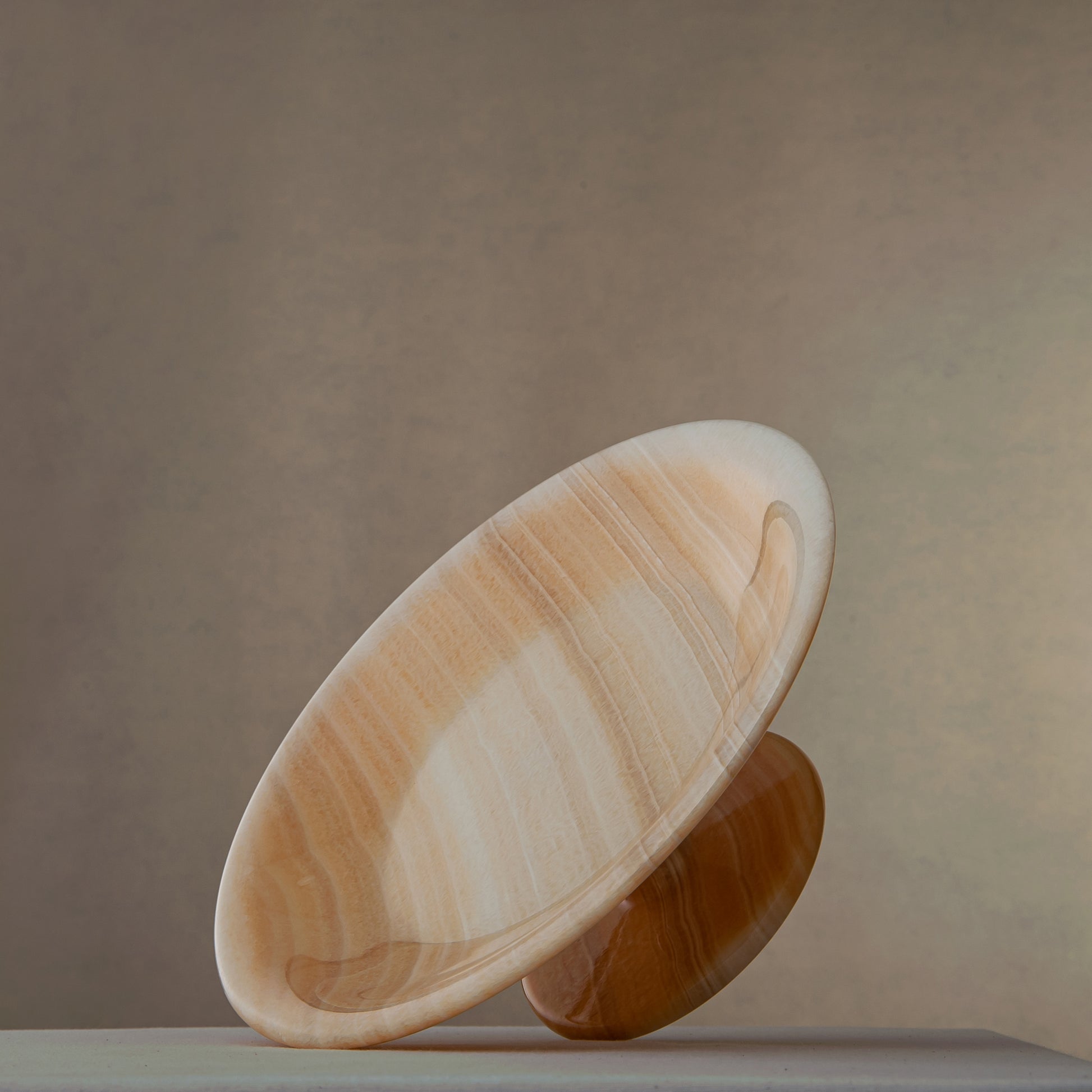 unique natural onyx bowl with warm flowing layers and luminous surface centerpiece
