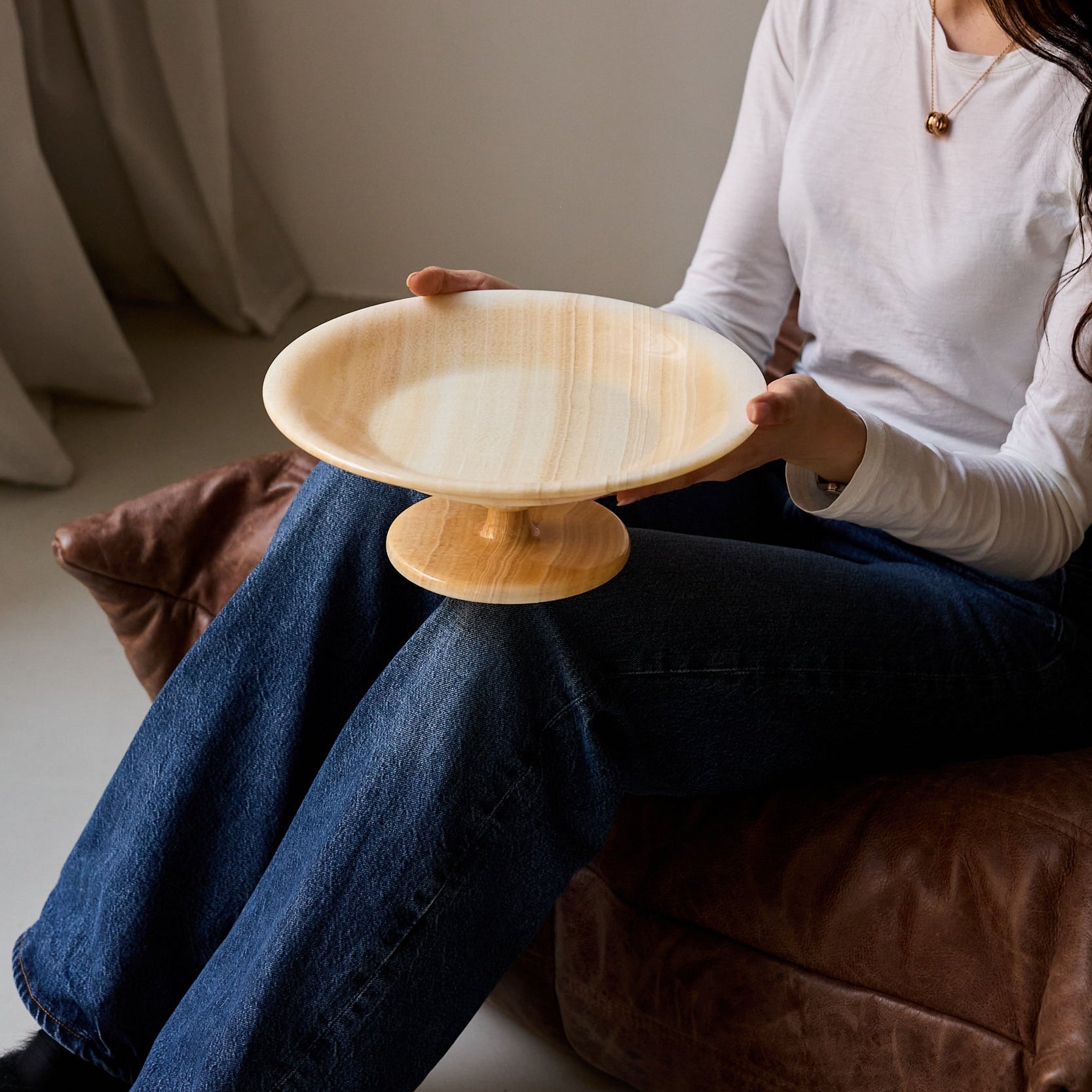 unique natural onyx bowl with warm flowing layers and luminous surface centerpiece
