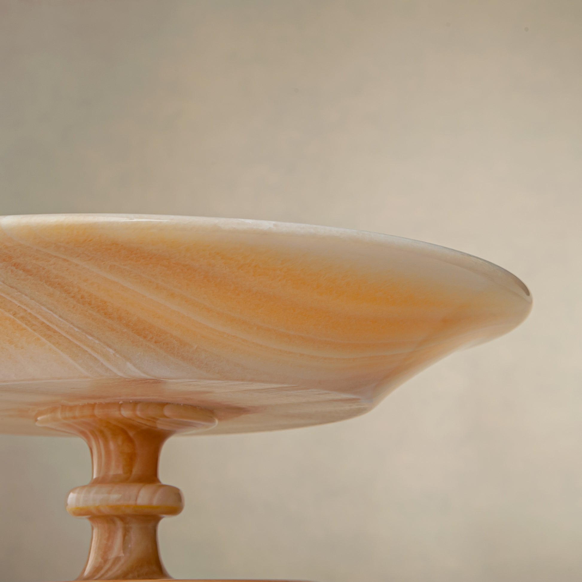 unique natural onyx bowl with warm flowing layers and luminous surface centerpiece
