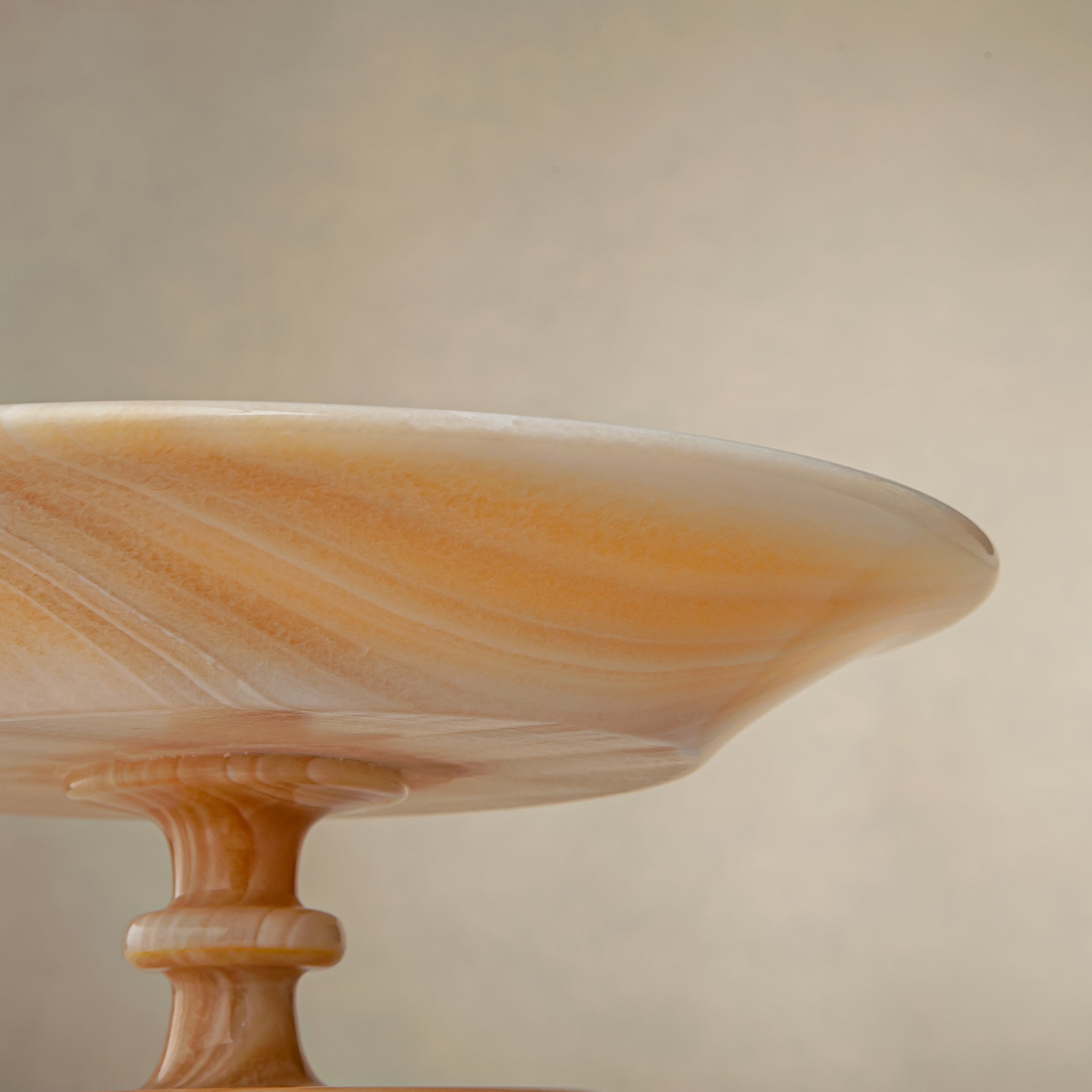 unique natural onyx bowl with warm flowing layers and luminous surface centerpiece
