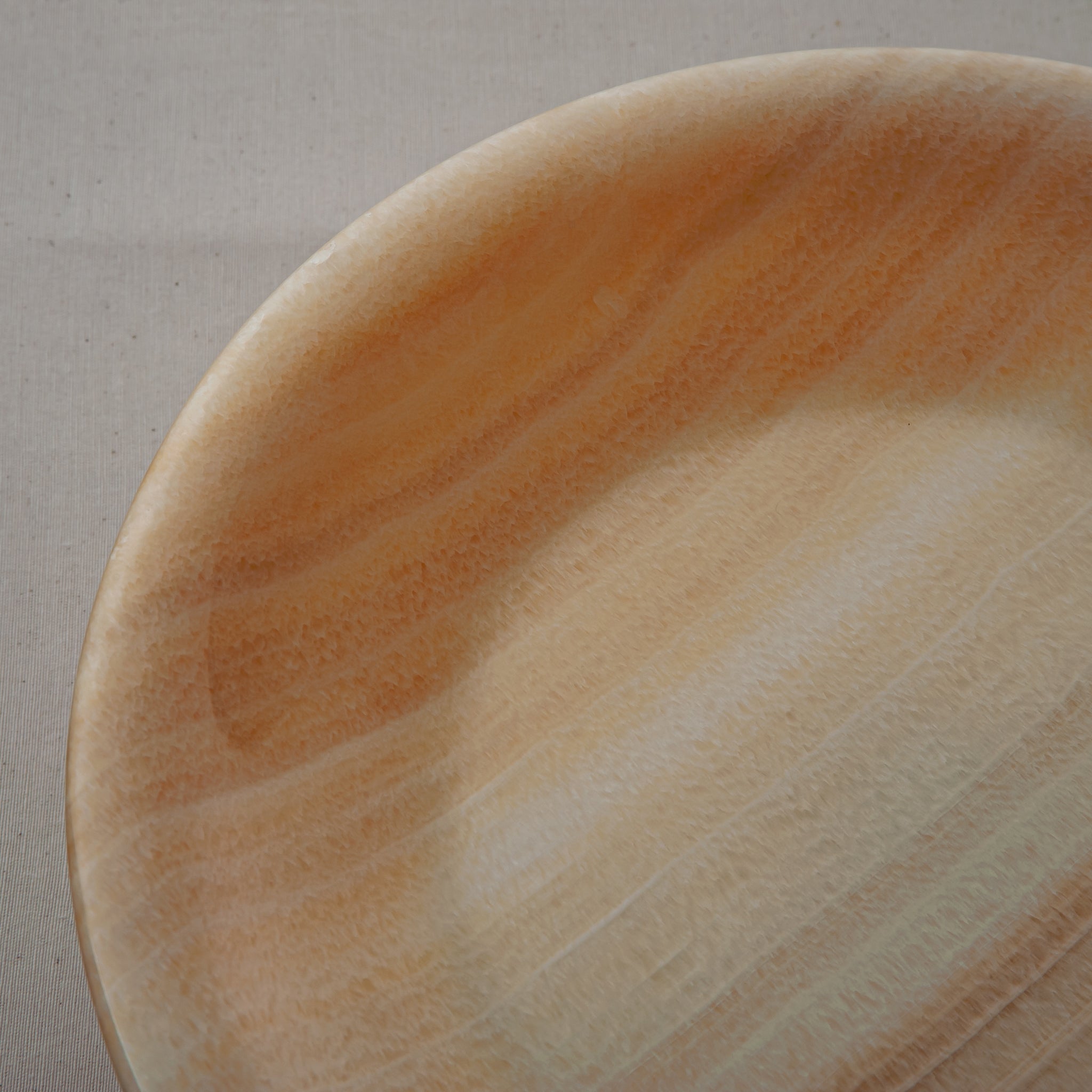 unique natural onyx bowl with warm flowing layers and luminous surface centerpiece
