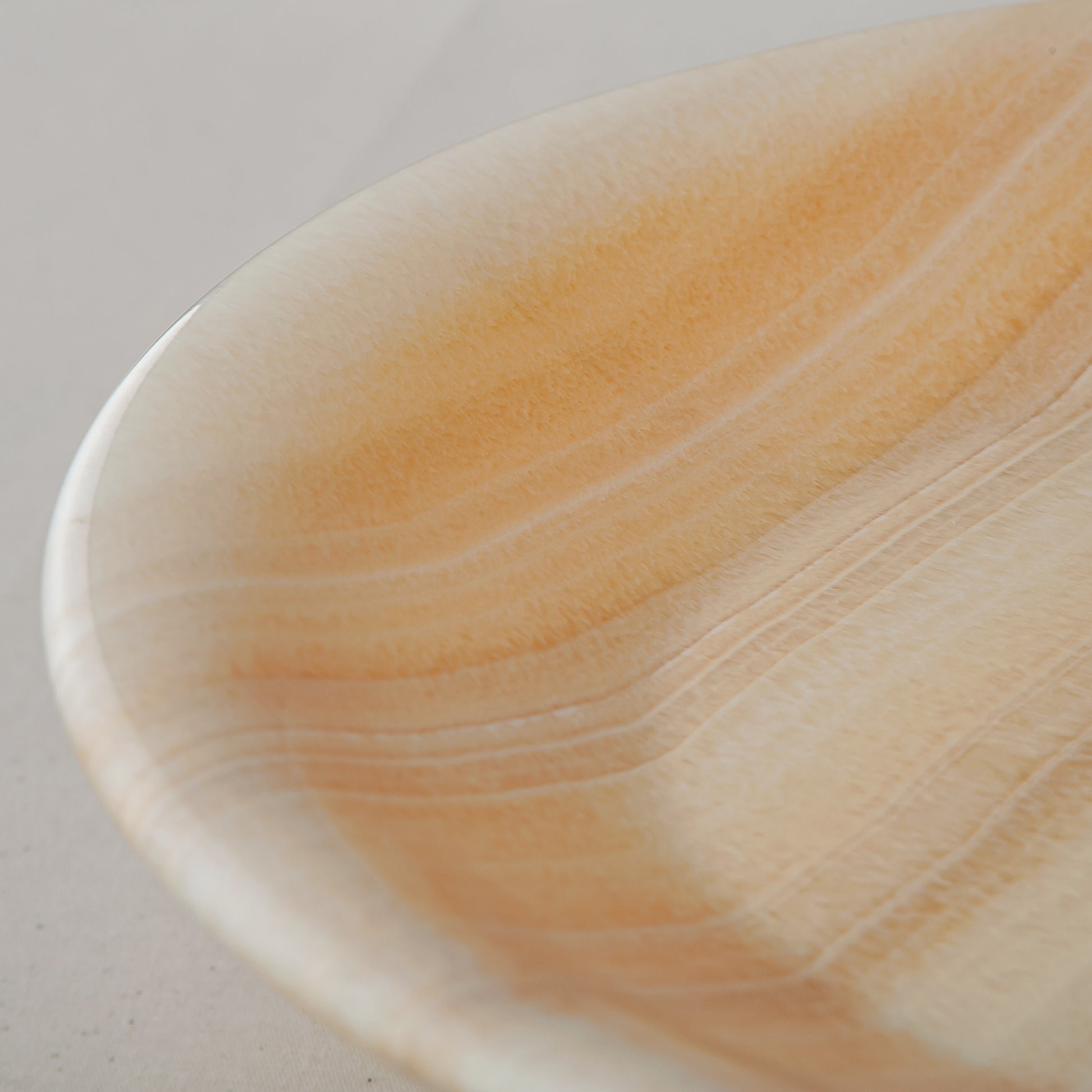 unique natural onyx bowl with warm flowing layers and luminous surface centerpiece
