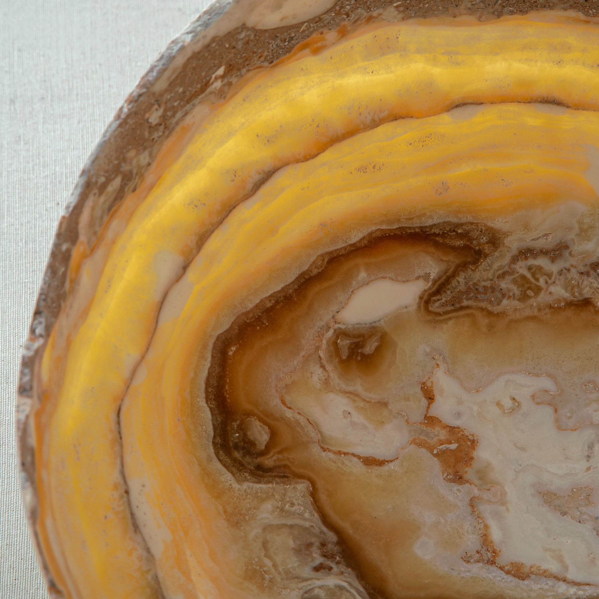 artisanal onyx bowl with translucent amber tones and irregular rim for coffee table styling
