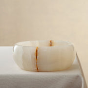 handcrafted onyx bowl with ivory surface and bold amber vein for luxury centerpiece
