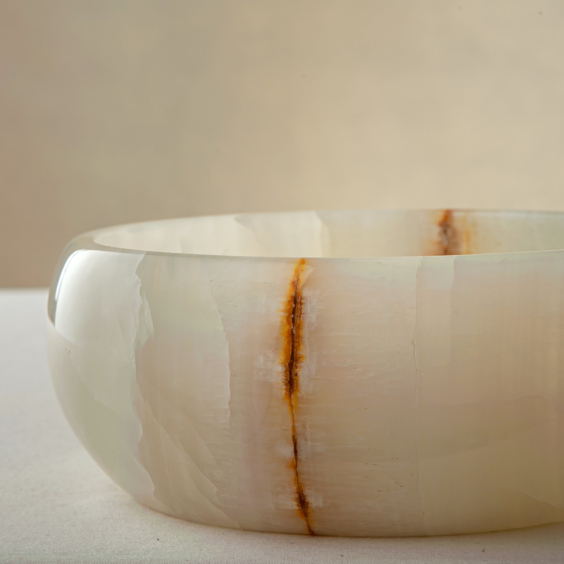unique natural onyx bowl with smooth polished finish and warm vertical veining
