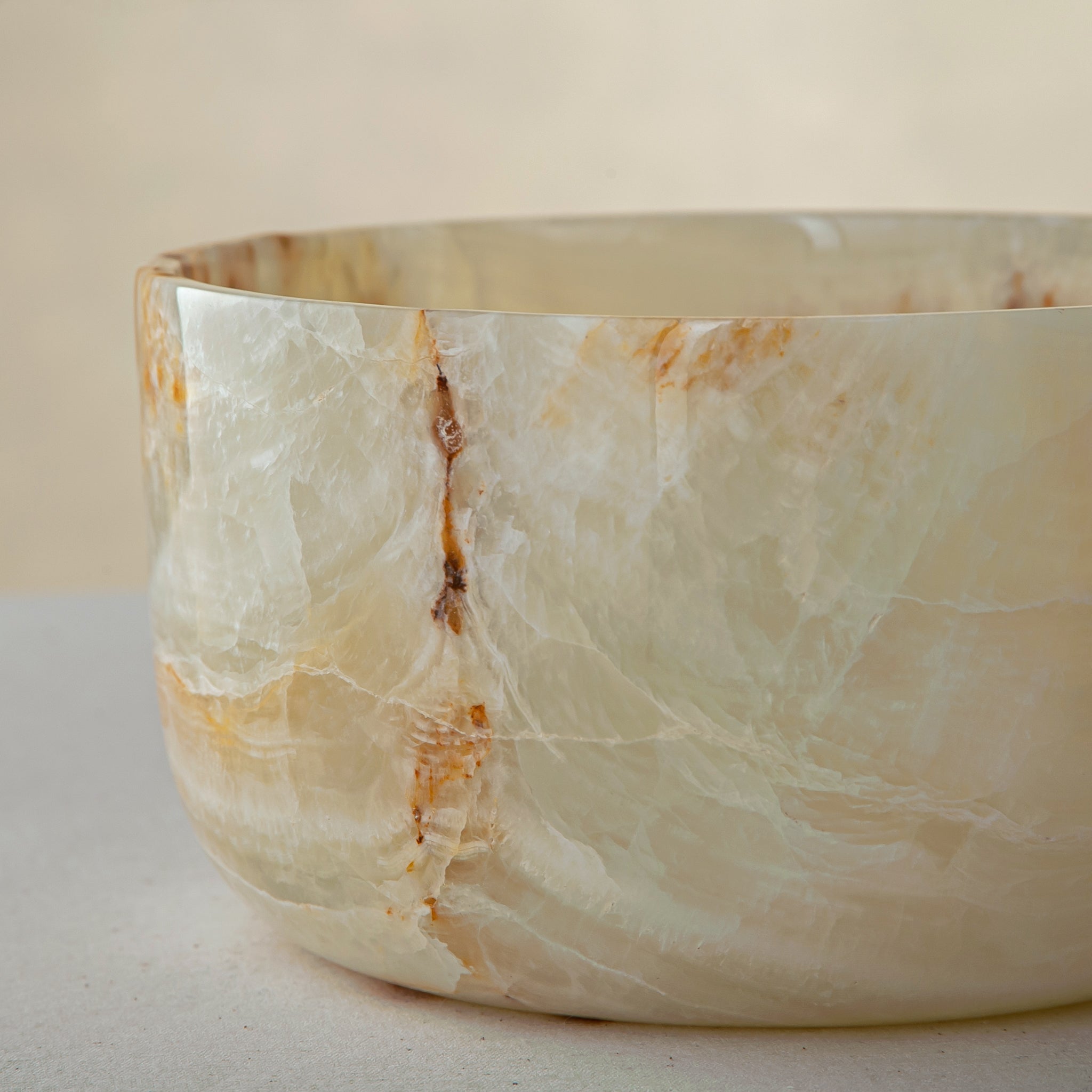 handcrafted onyx bowl with translucent ivory tone and amber veining for luxury table decor
