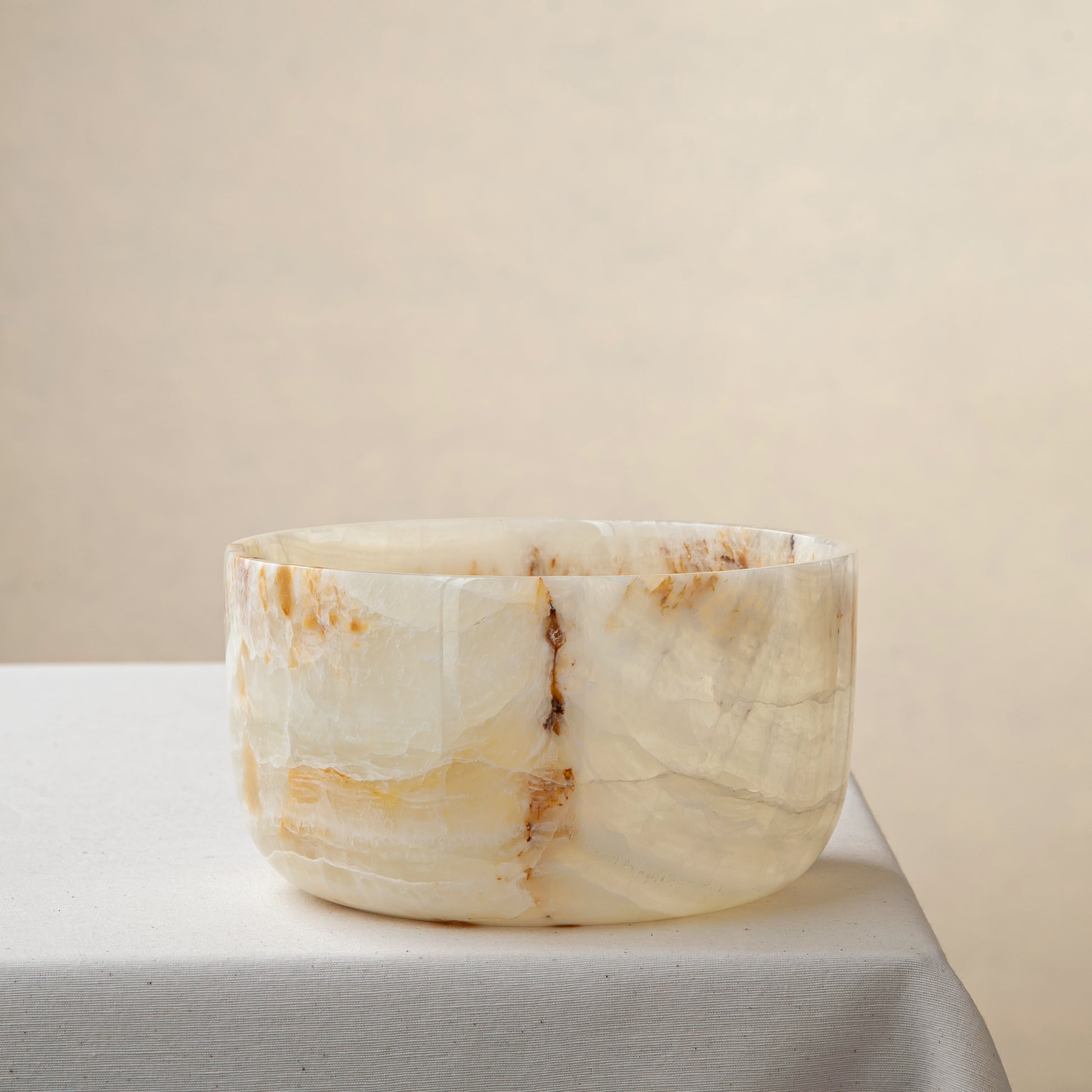 handcrafted onyx bowl with translucent ivory tone and amber veining for luxury table decor
