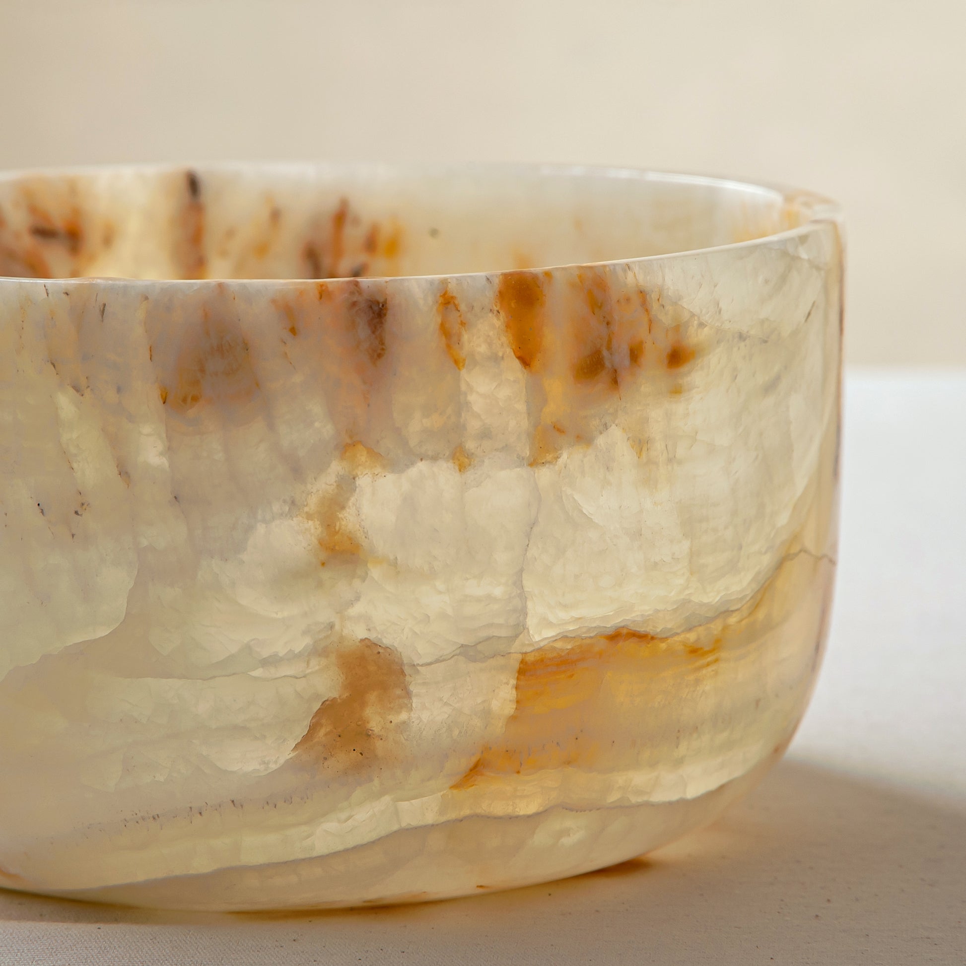 handcrafted onyx bowl with translucent ivory tone and amber veining for luxury table decor
