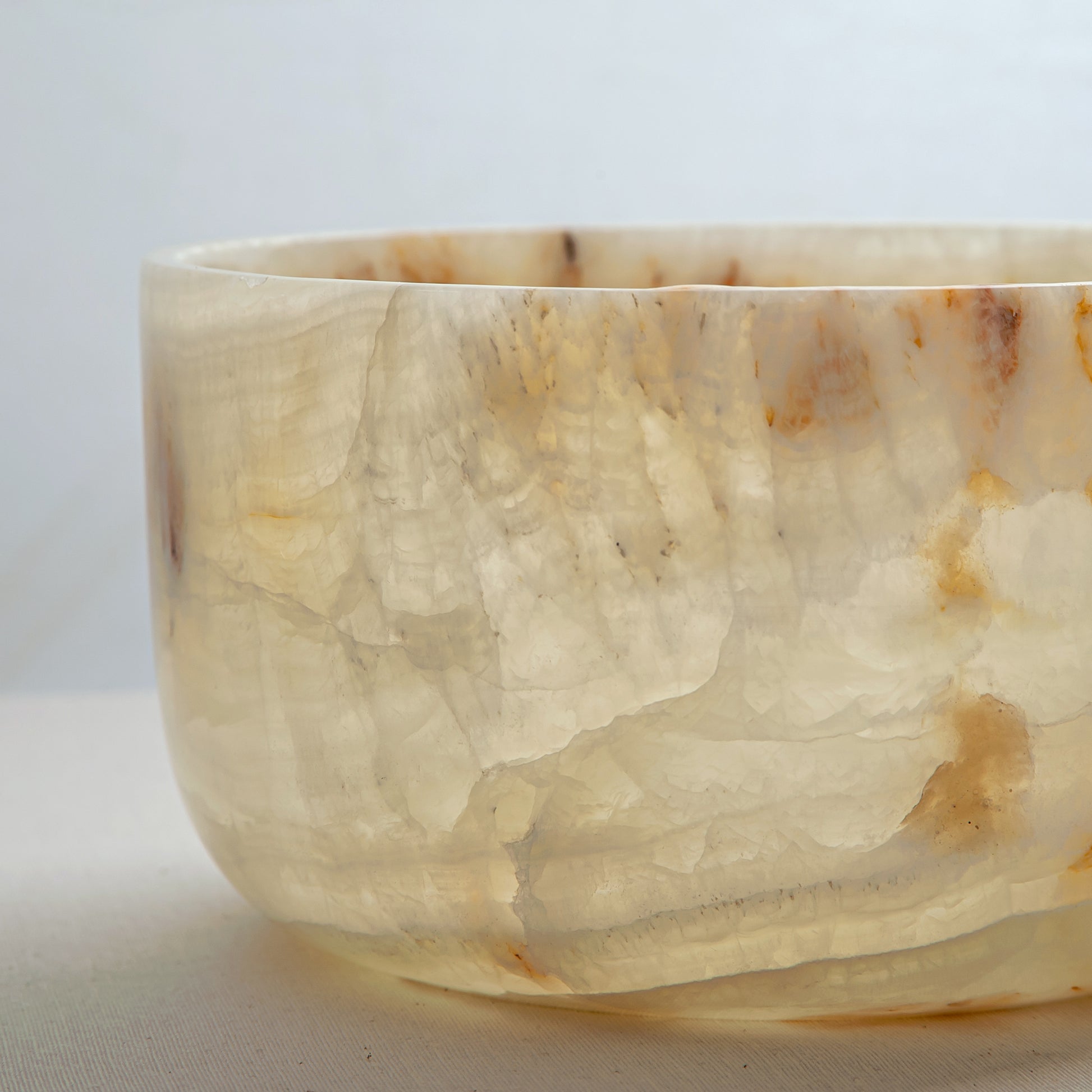 handcrafted onyx bowl with translucent ivory tone and amber veining for luxury table decor

