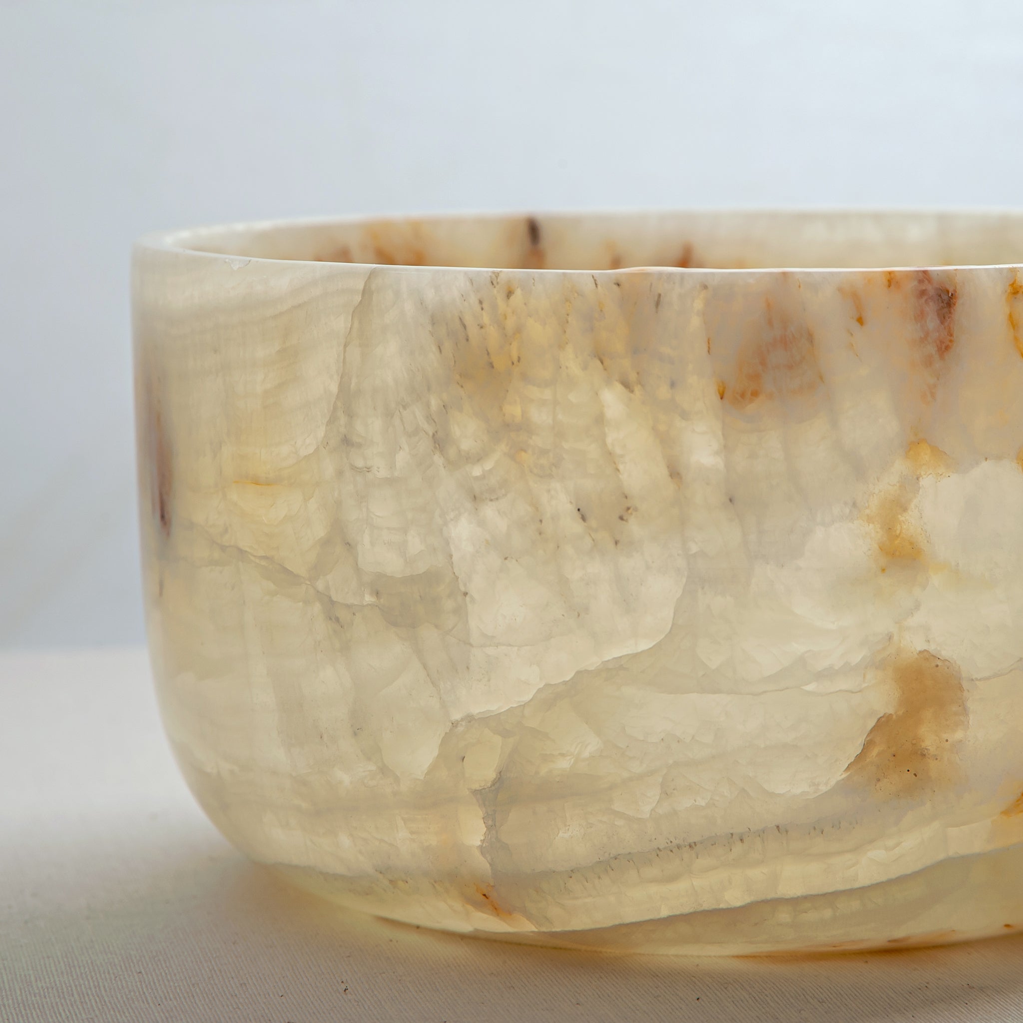 handcrafted onyx bowl with translucent ivory tone and amber veining for luxury table decor
