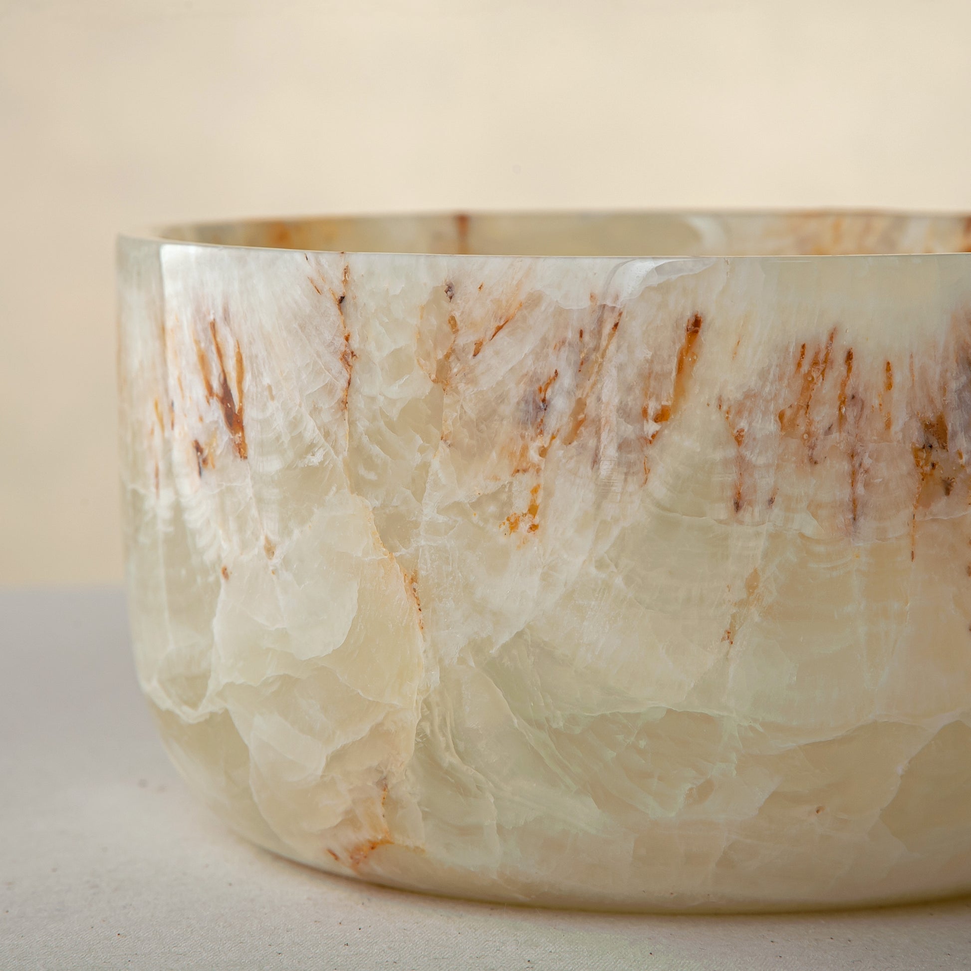 handcrafted onyx bowl with translucent ivory tone and amber veining for luxury table decor
