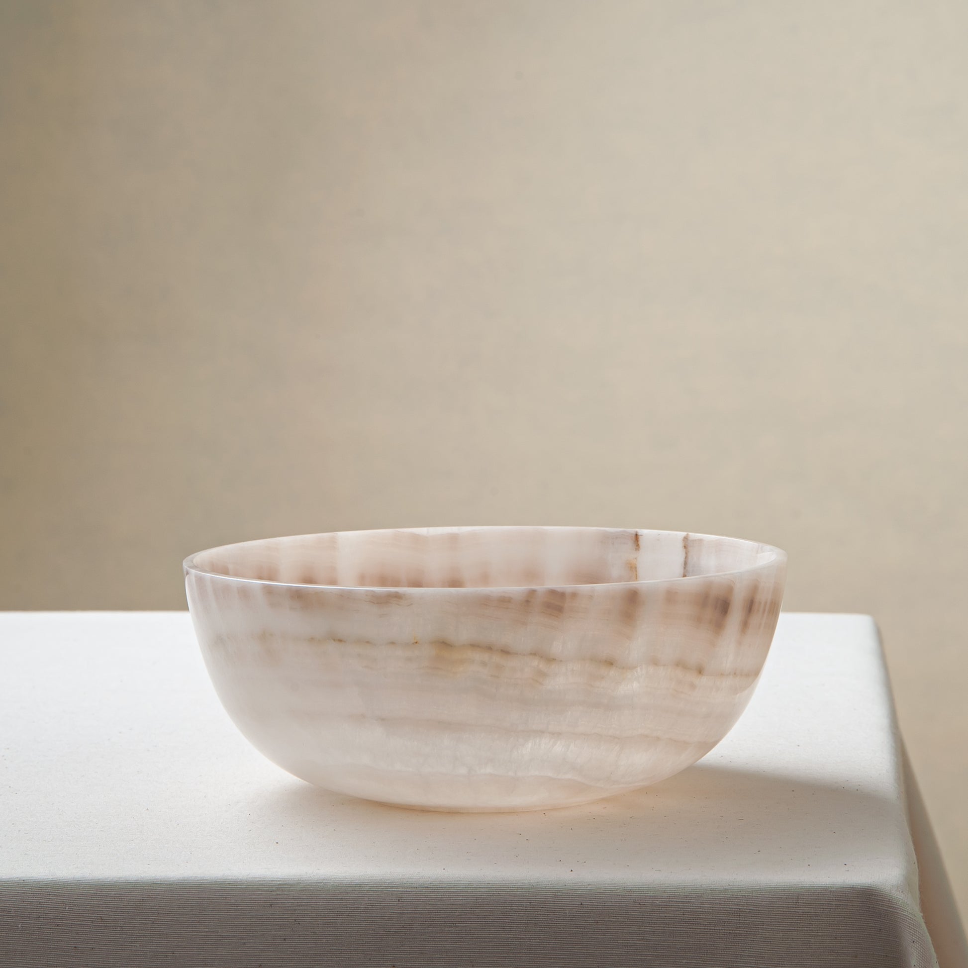 handcrafted onyx bowl with ivory and blush beige tones and soft translucent layers for elegant decor
