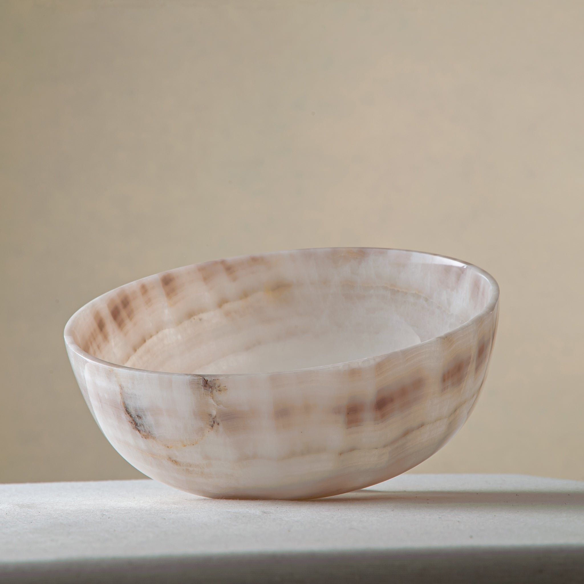 handcrafted onyx bowl with ivory and blush beige tones and soft translucent layers for elegant decor
