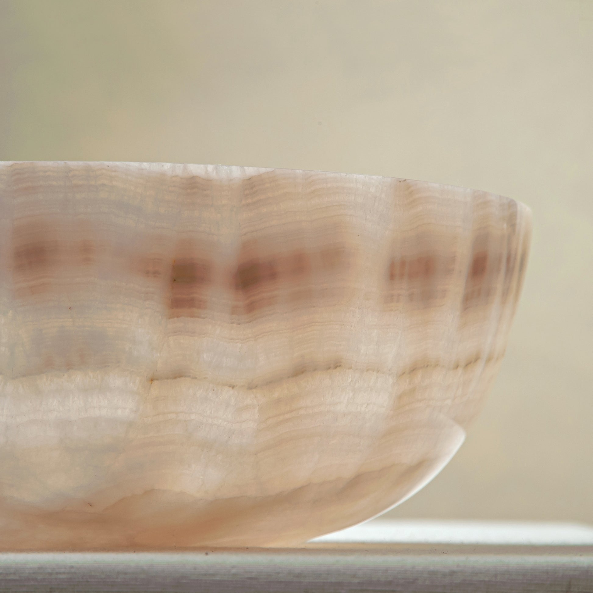 handcrafted onyx bowl with ivory and blush beige tones and soft translucent layers for elegant decor
