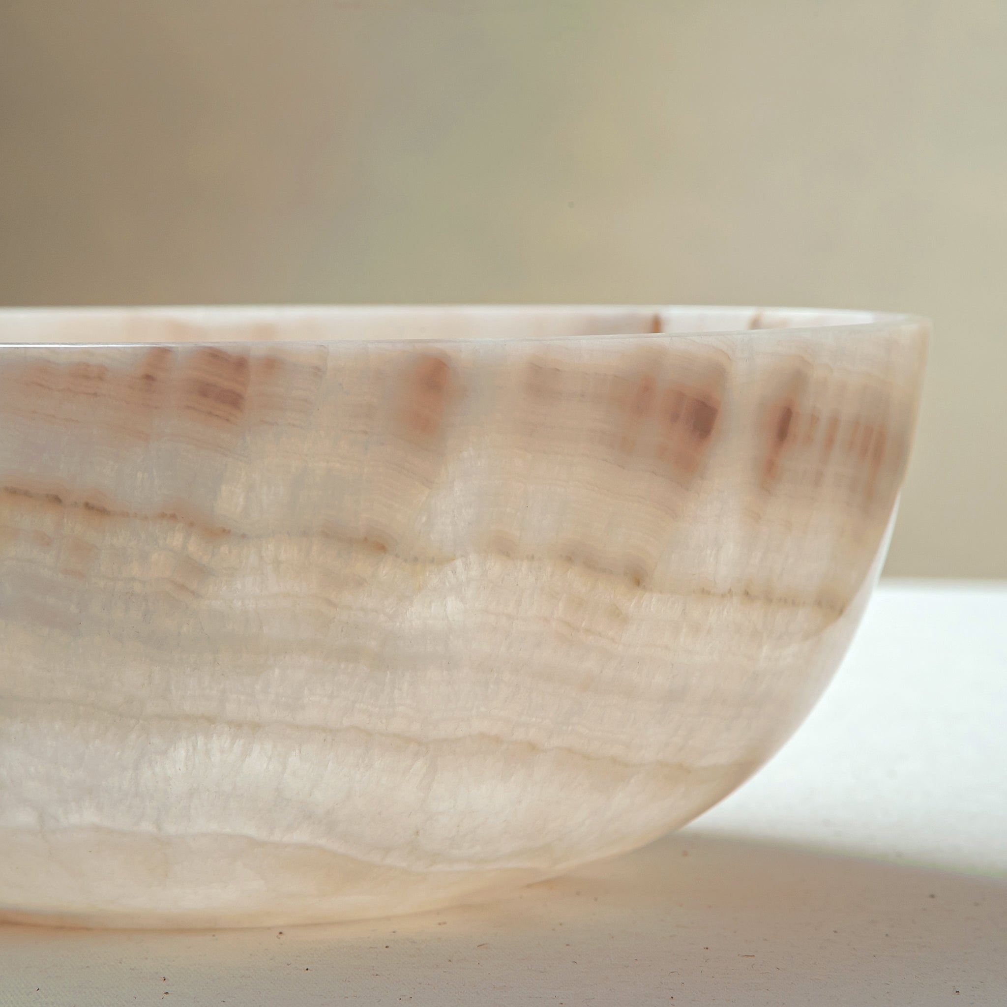 handcrafted onyx bowl with ivory and blush beige tones and soft translucent layers for elegant decor
