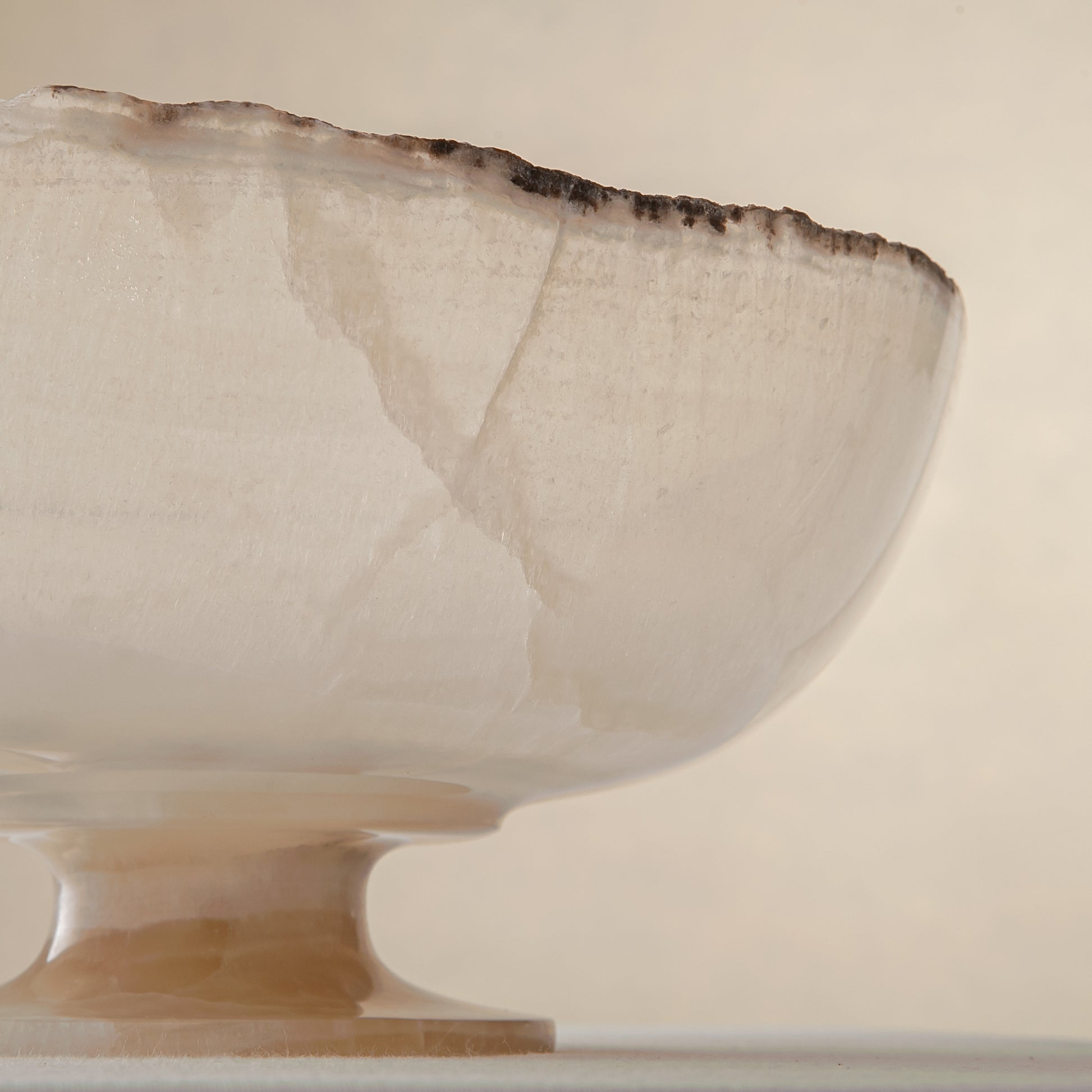 handcrafted onyx bowl in translucent ivory stone with natural rugged edge for luxury decor
