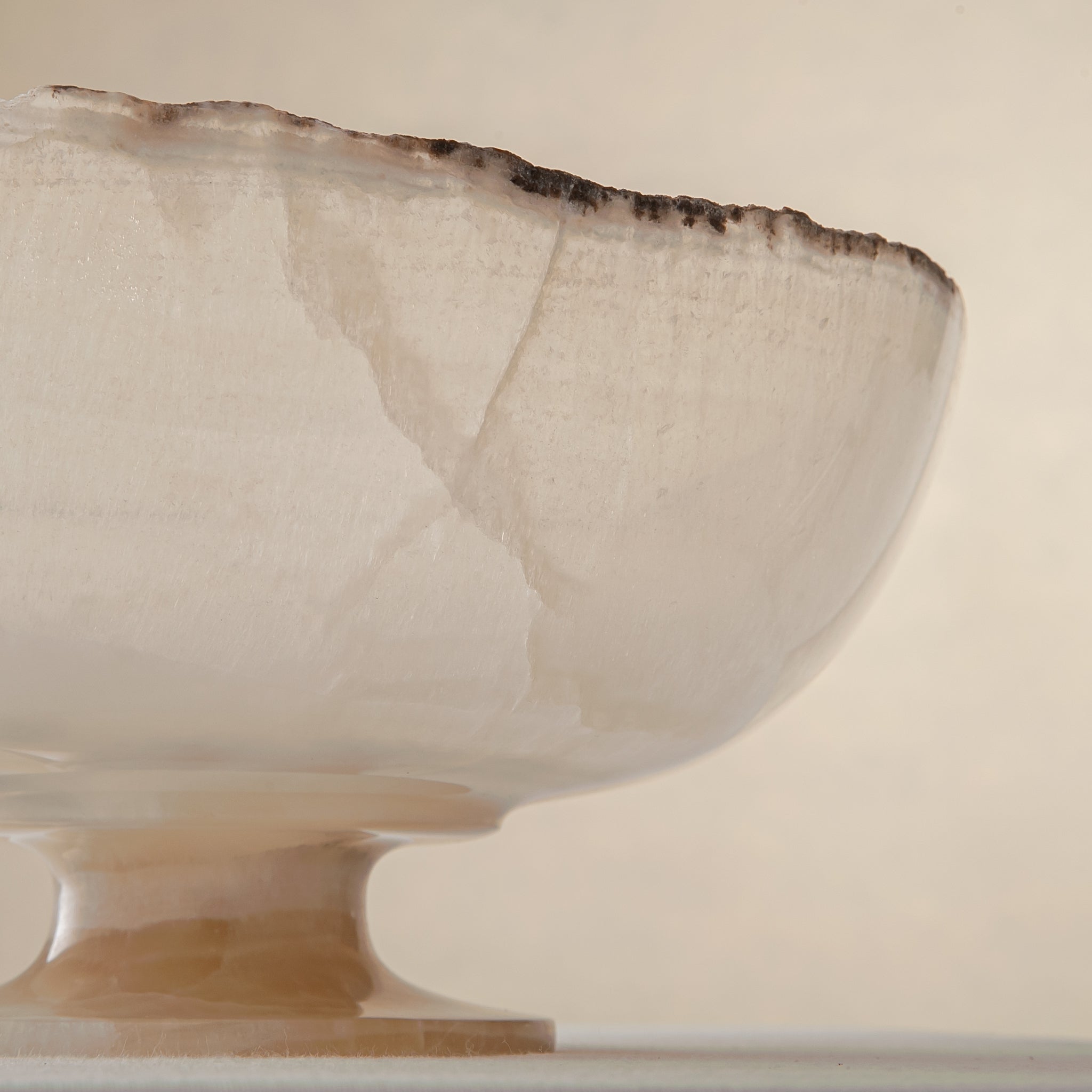 handcrafted onyx bowl in translucent ivory stone with natural rugged edge for luxury decor

