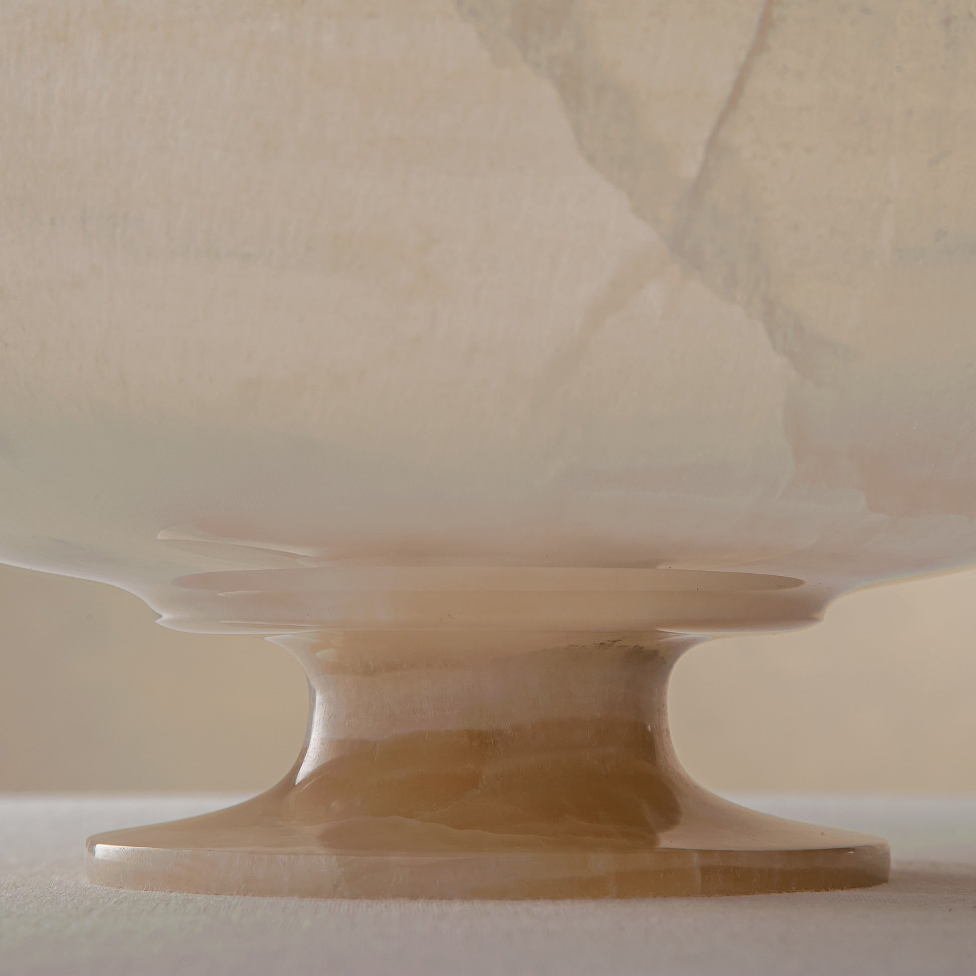 handcrafted onyx bowl in translucent ivory stone with natural rugged edge for luxury decor
