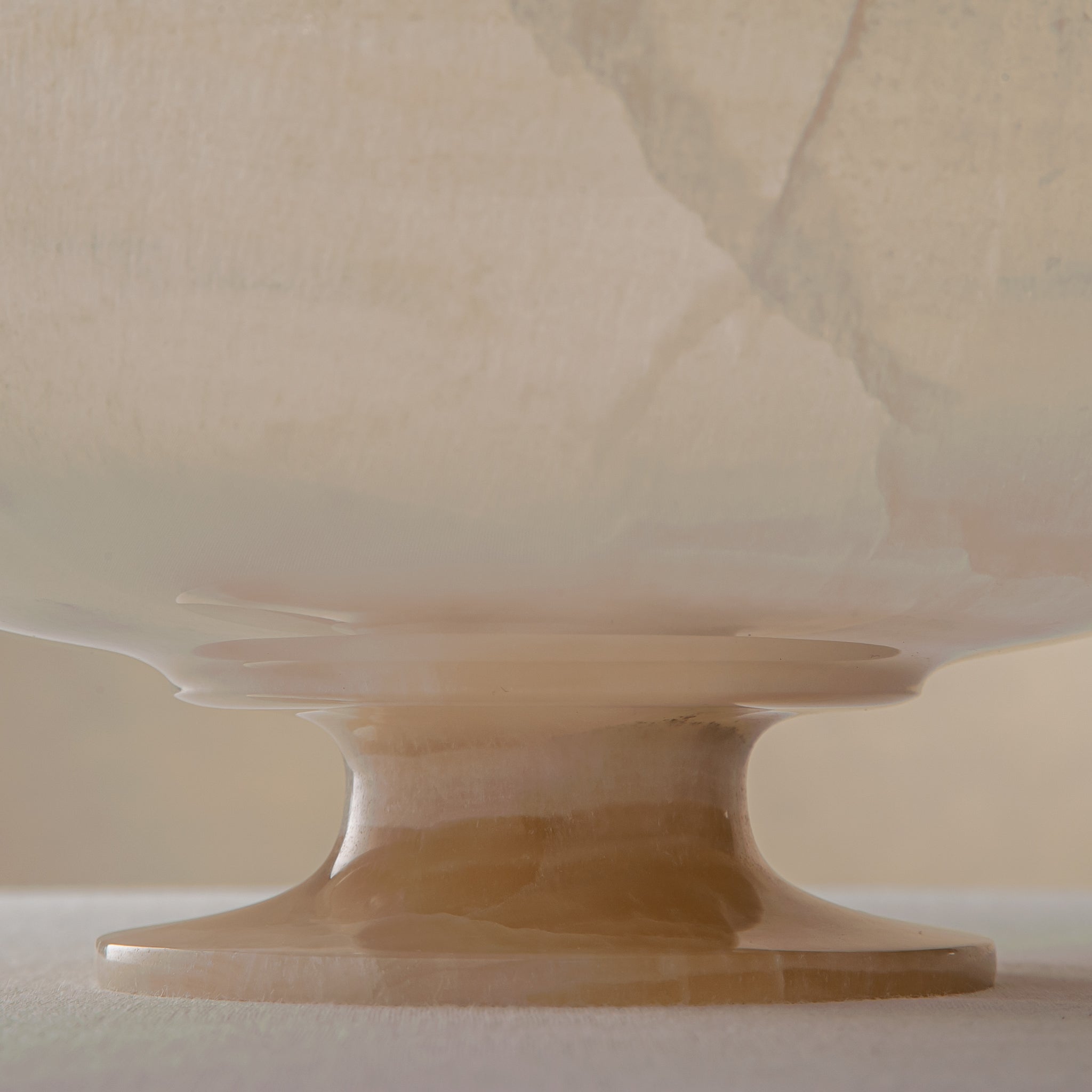 handcrafted onyx bowl in translucent ivory stone with natural rugged edge for luxury decor
