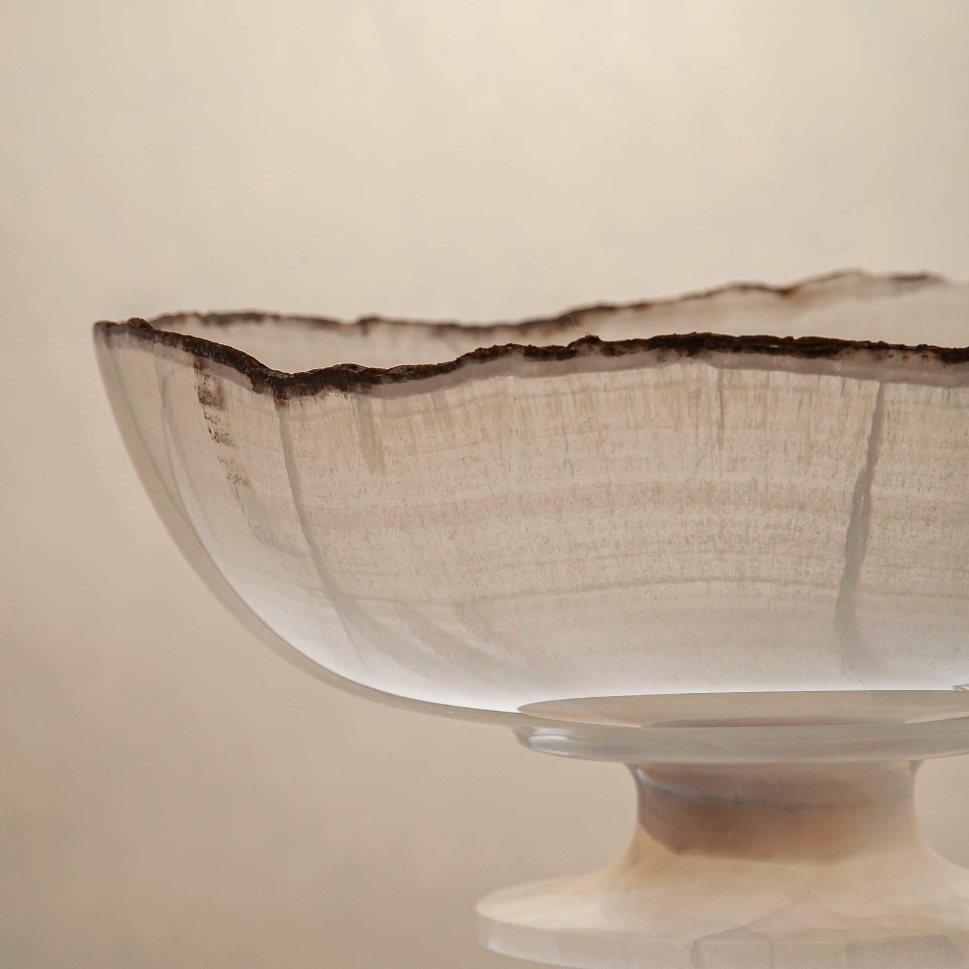 handcrafted onyx bowl in translucent ivory stone with natural rugged edge for luxury decor

