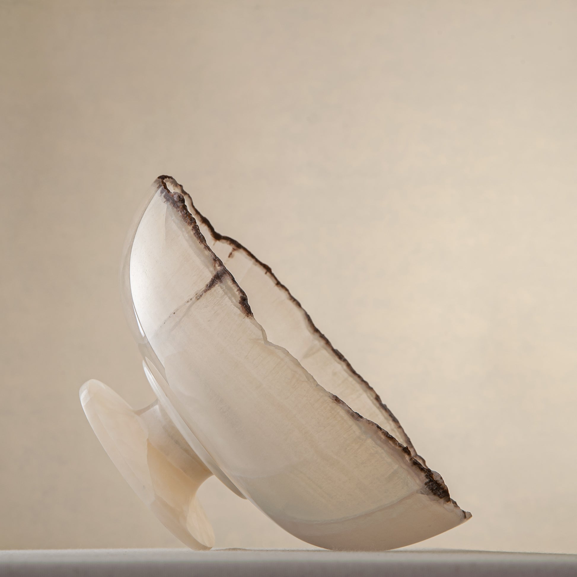handcrafted onyx bowl in translucent ivory stone with natural rugged edge for luxury decor
