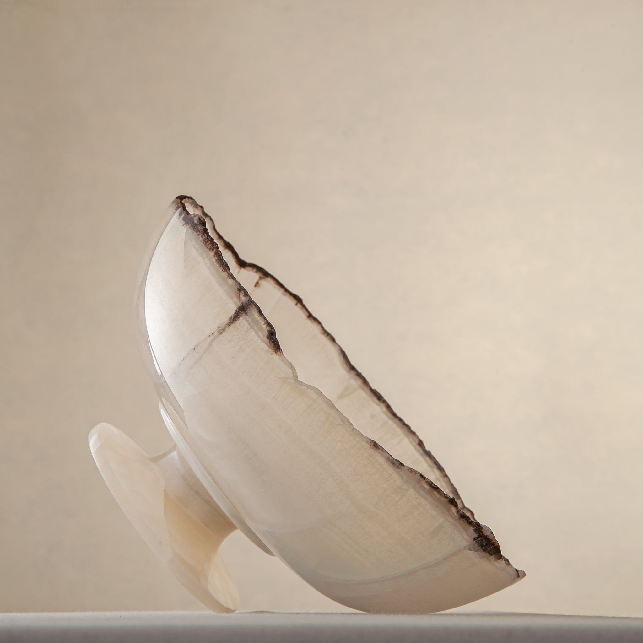 handcrafted onyx bowl in translucent ivory stone with natural rugged edge for luxury decor
