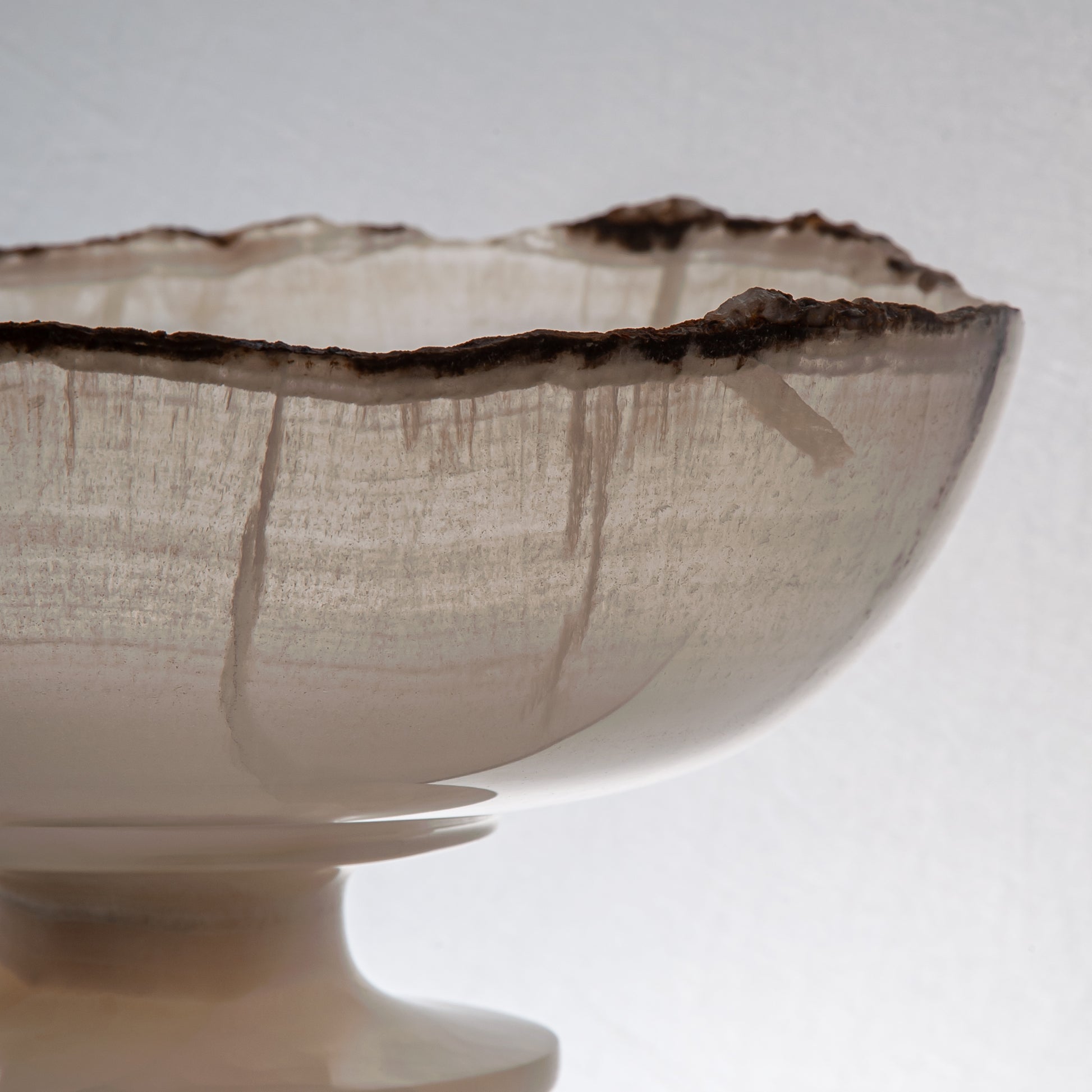 handcrafted onyx bowl in translucent ivory stone with natural rugged edge for luxury decor
