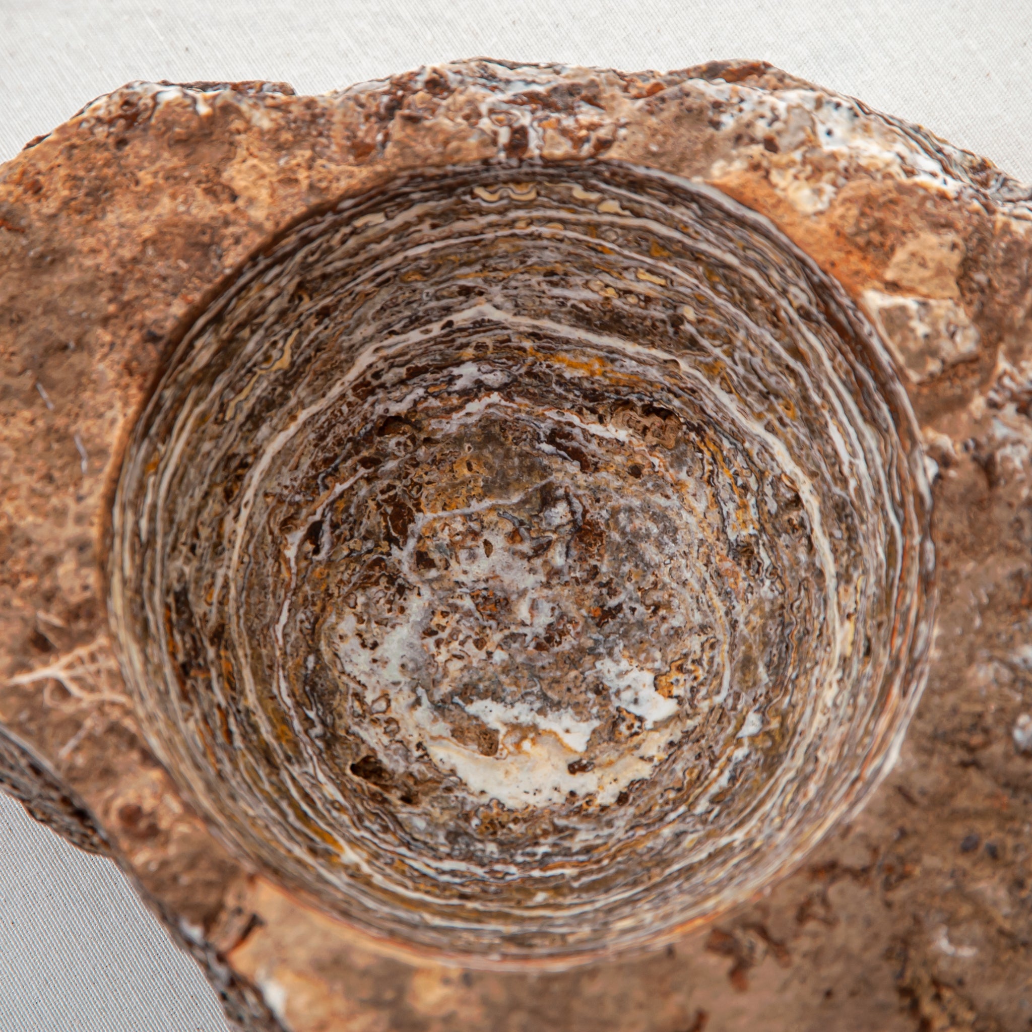 handcrafted onyx bowl with layered brown and ivory bands as sculptural centerpiece
