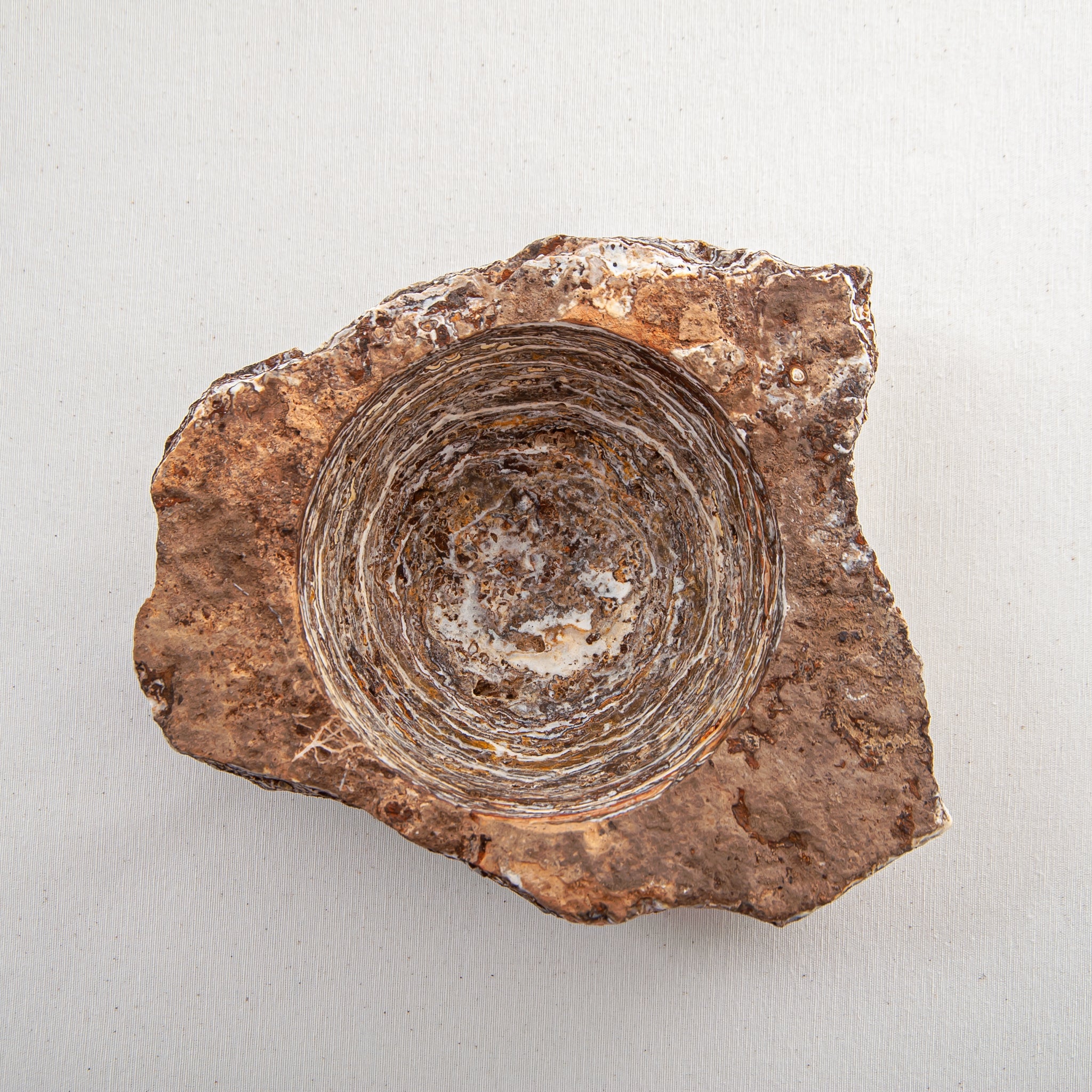 handcrafted onyx bowl with layered brown and ivory bands as sculptural centerpiece
