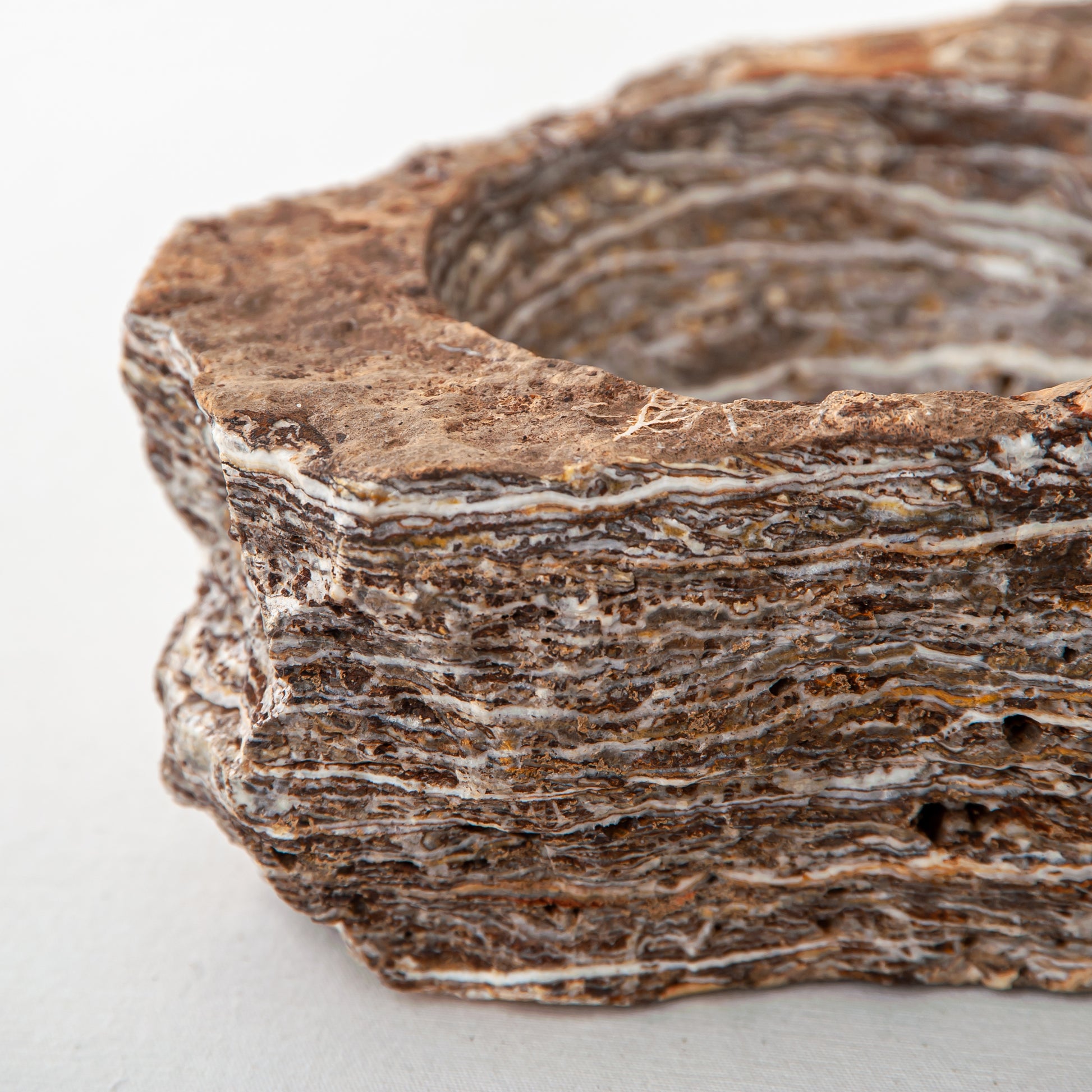 handcrafted onyx bowl with layered brown and ivory bands as sculptural centerpiece
