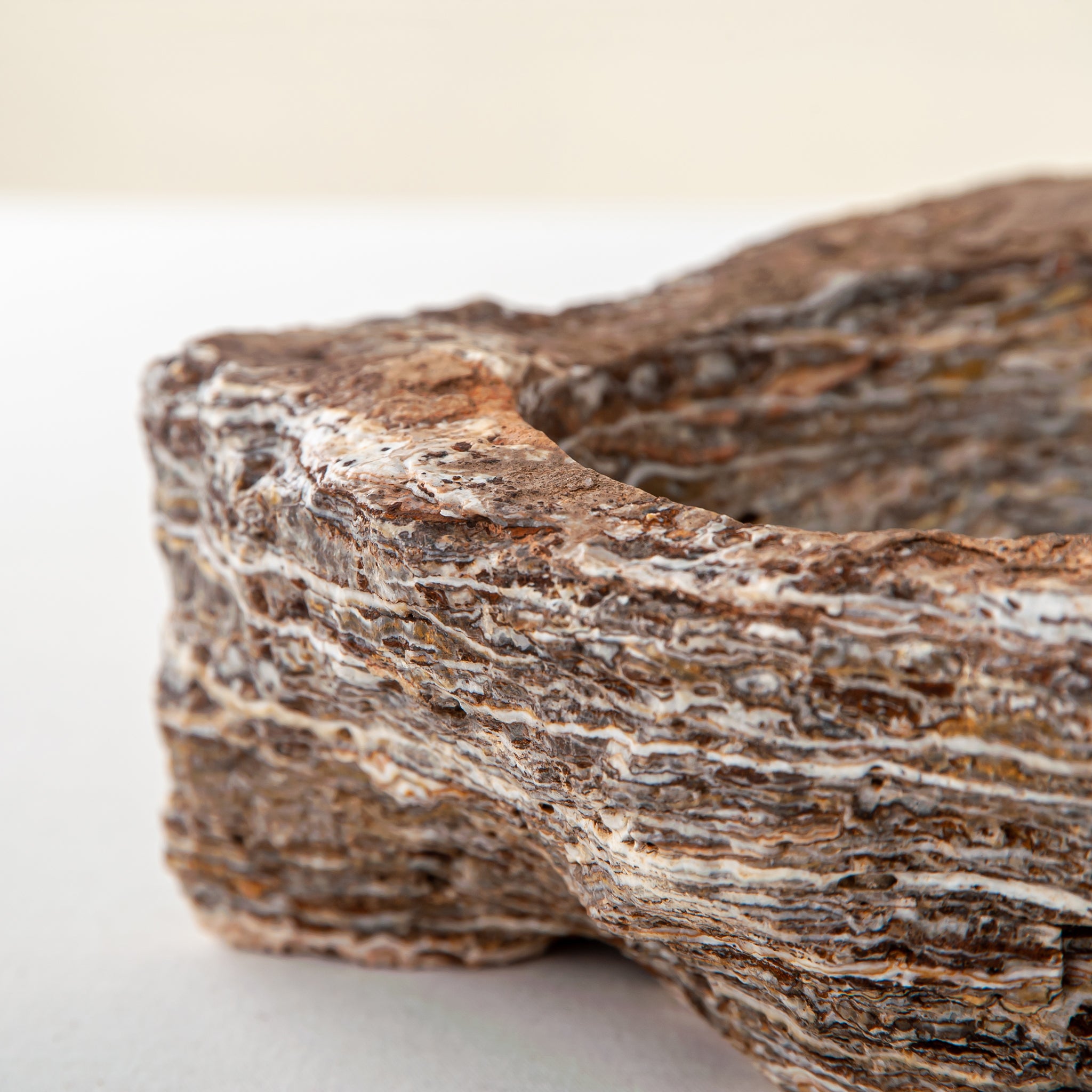 handcrafted onyx bowl with layered brown and ivory bands as sculptural centerpiece
