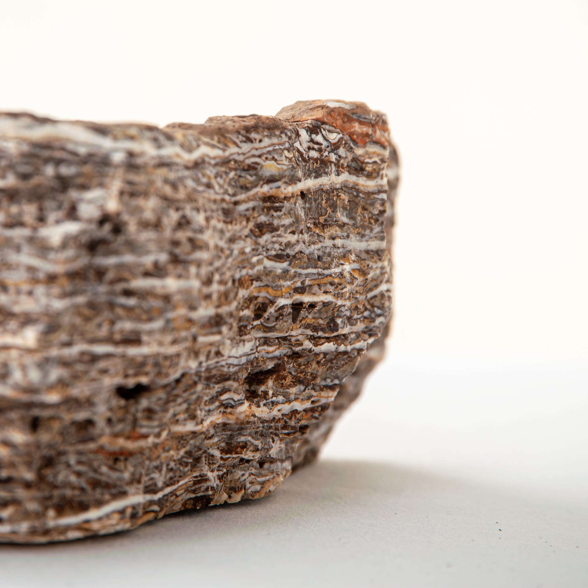 handcrafted onyx bowl with layered brown and ivory bands as sculptural centerpiece
