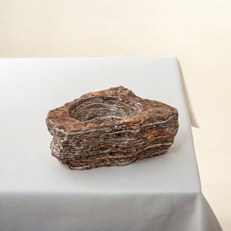 handcrafted onyx bowl with layered brown and ivory bands as sculptural centerpiece
