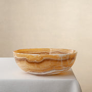 handcrafted onyx bowl with golden amber banded veining and smooth polished finish
