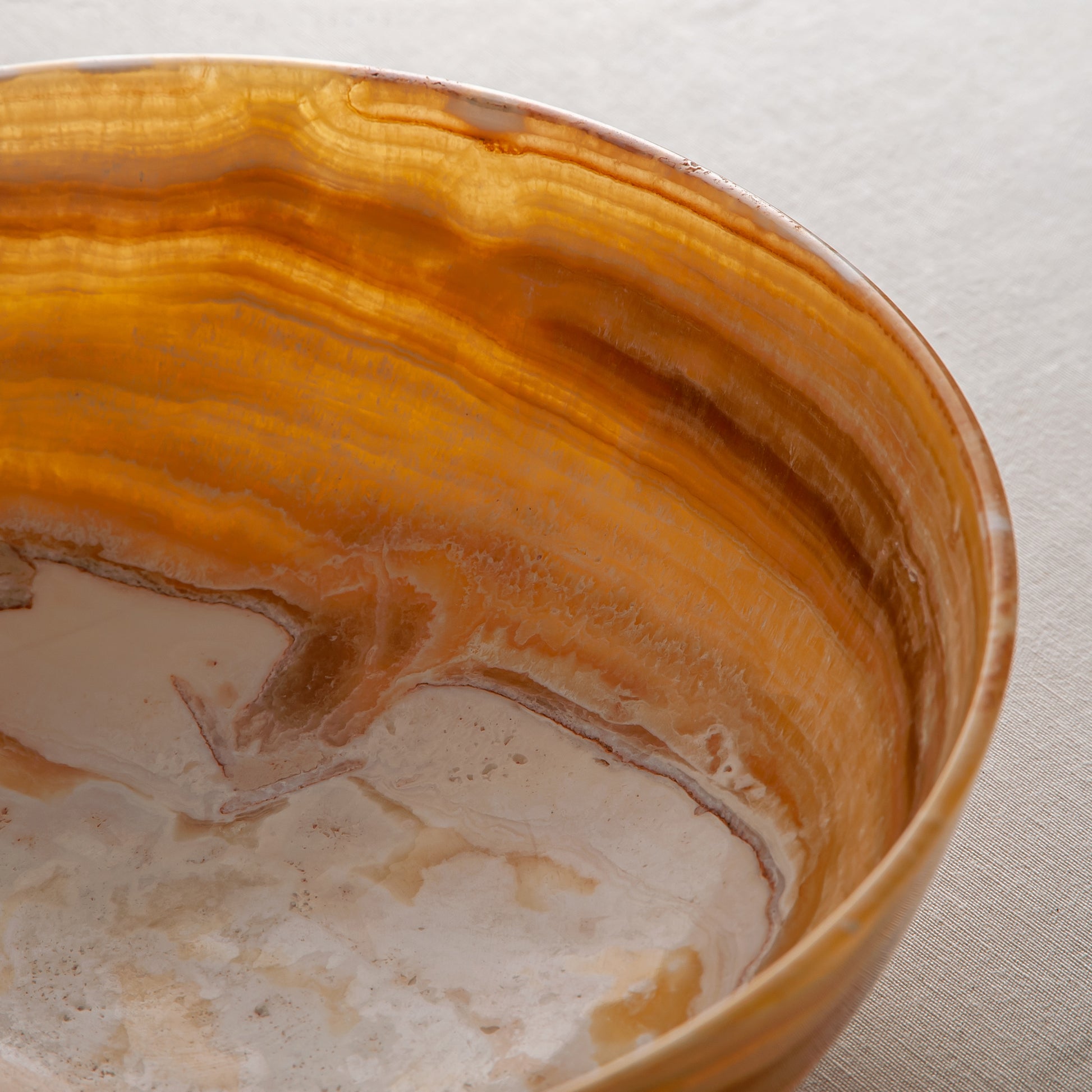 handcrafted onyx bowl with golden amber banded veining and smooth polished finish
