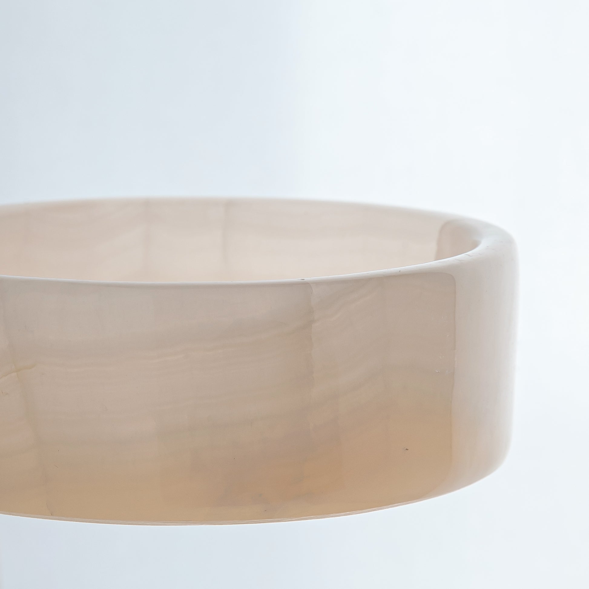 handcrafted onyx bowl in low cylindrical shape with soft white and blush tones for modern decor
