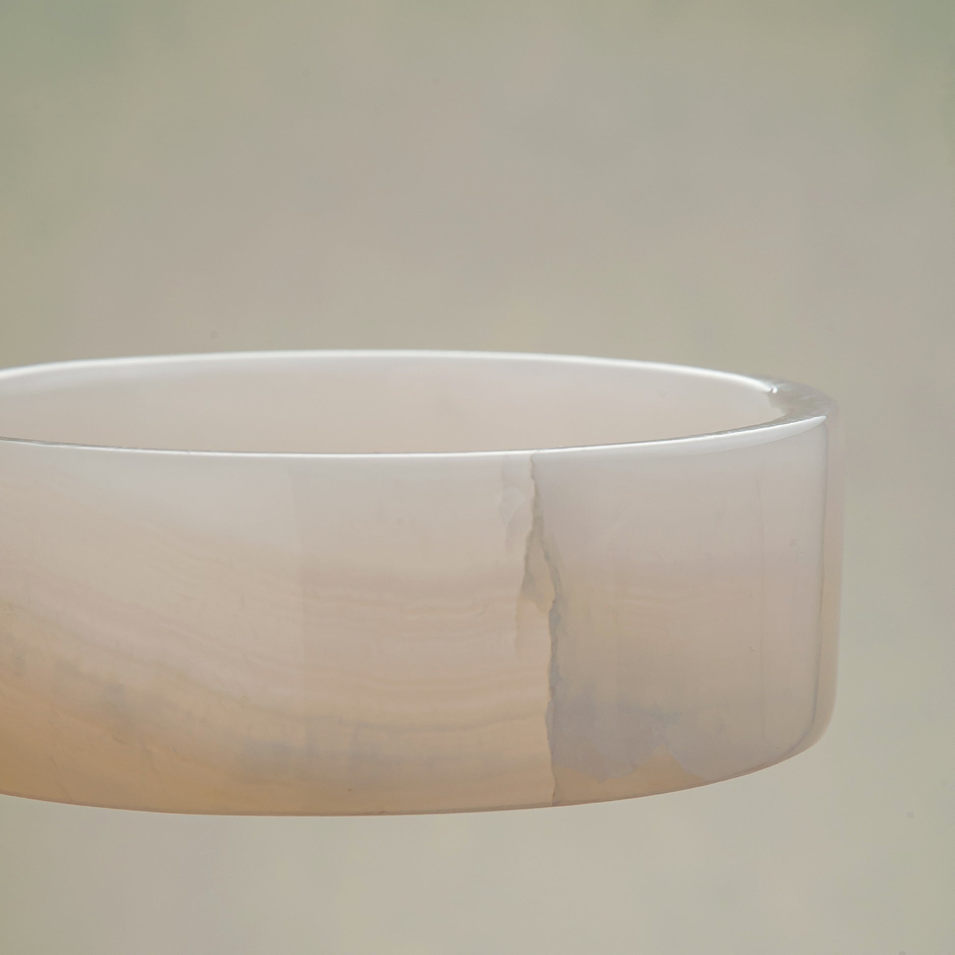 handcrafted onyx bowl in low cylindrical shape with soft white and blush tones for modern decor
