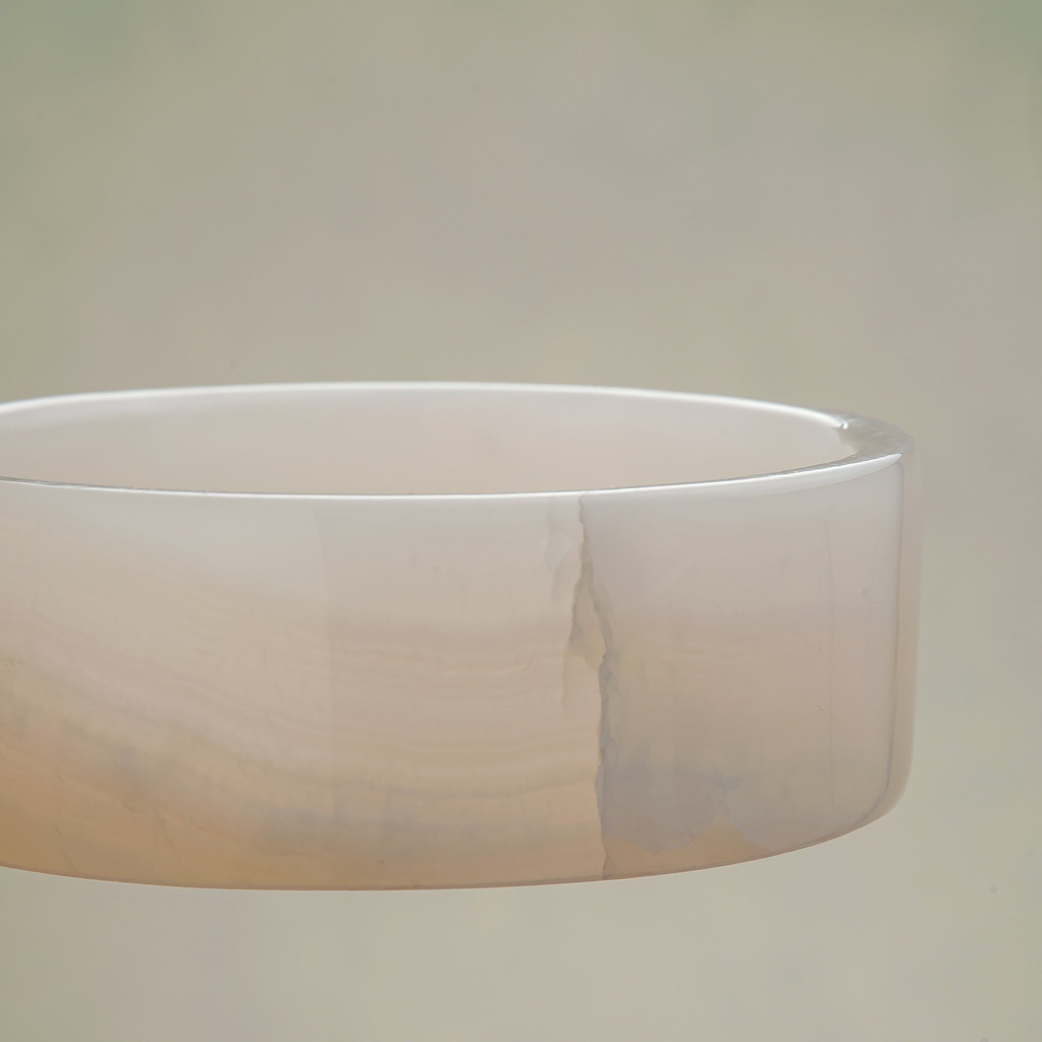 handcrafted onyx bowl in low cylindrical shape with soft white and blush tones for modern decor
